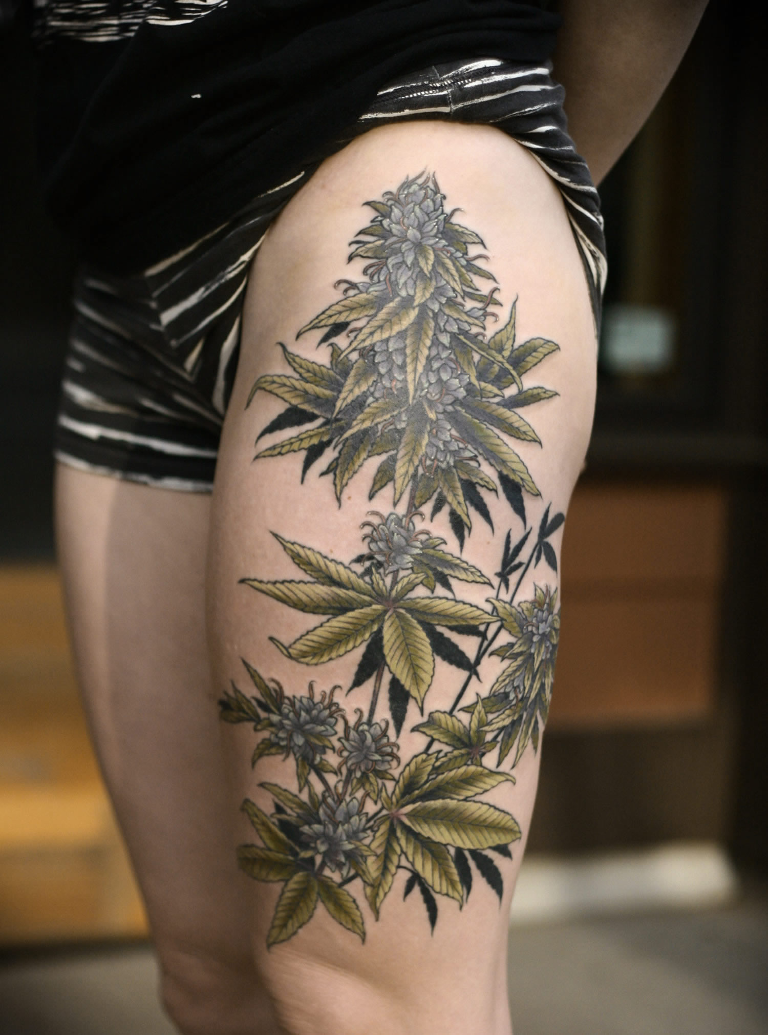 plants, tattoo on thigh, naturalistic
