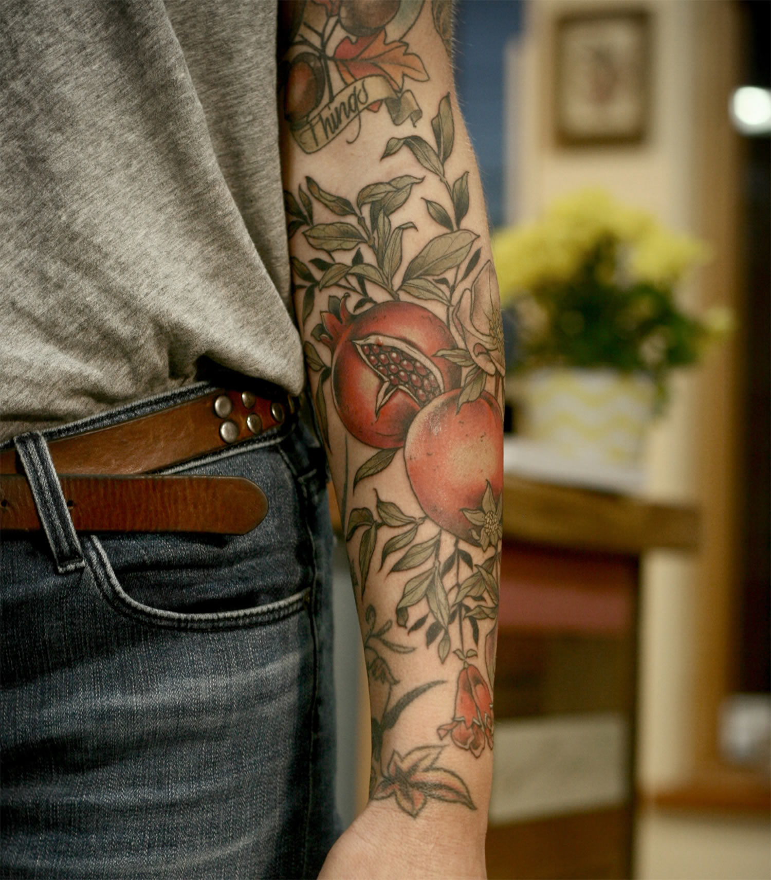 pomegranate and foliage tattoo sleeve