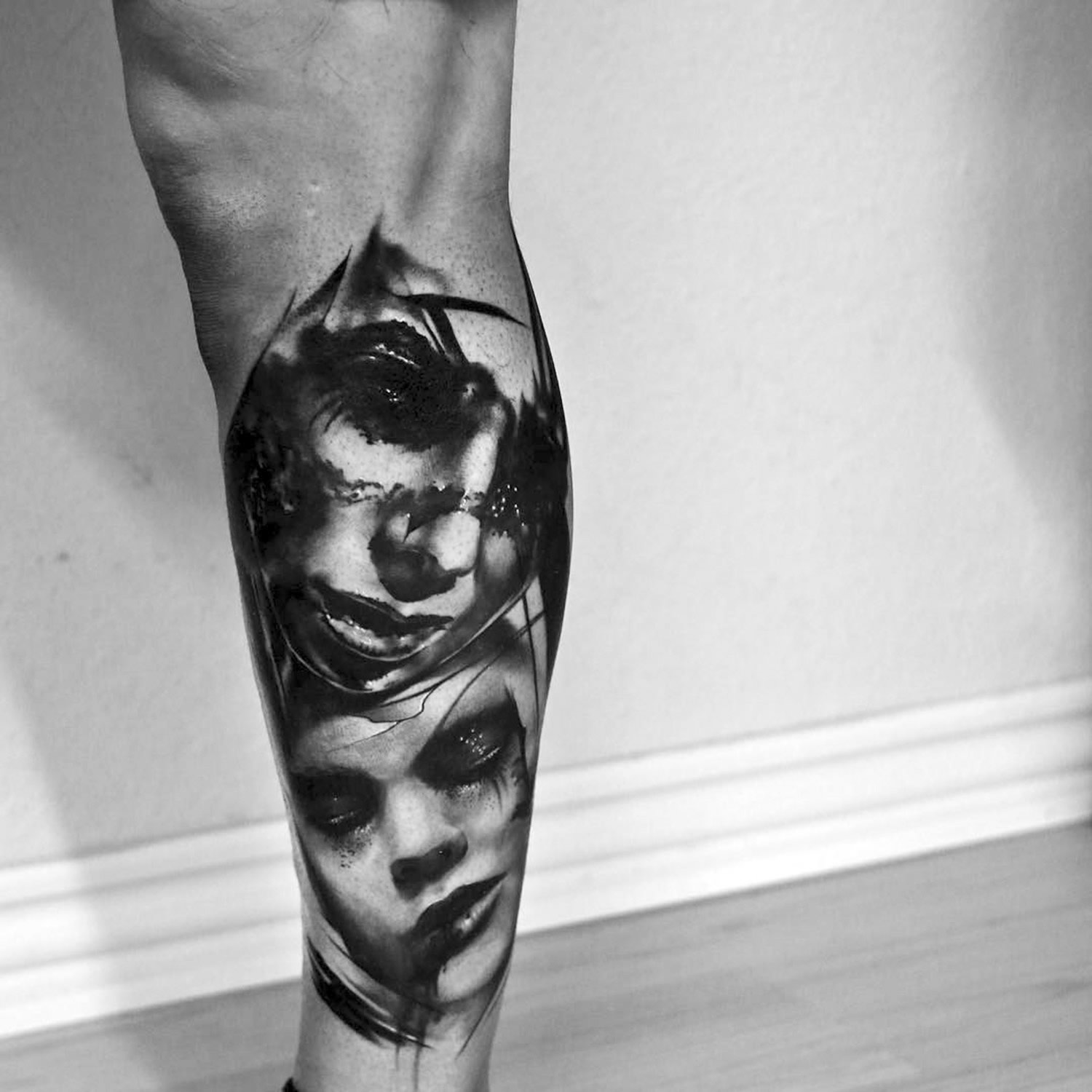 two portraits on leg, black ink