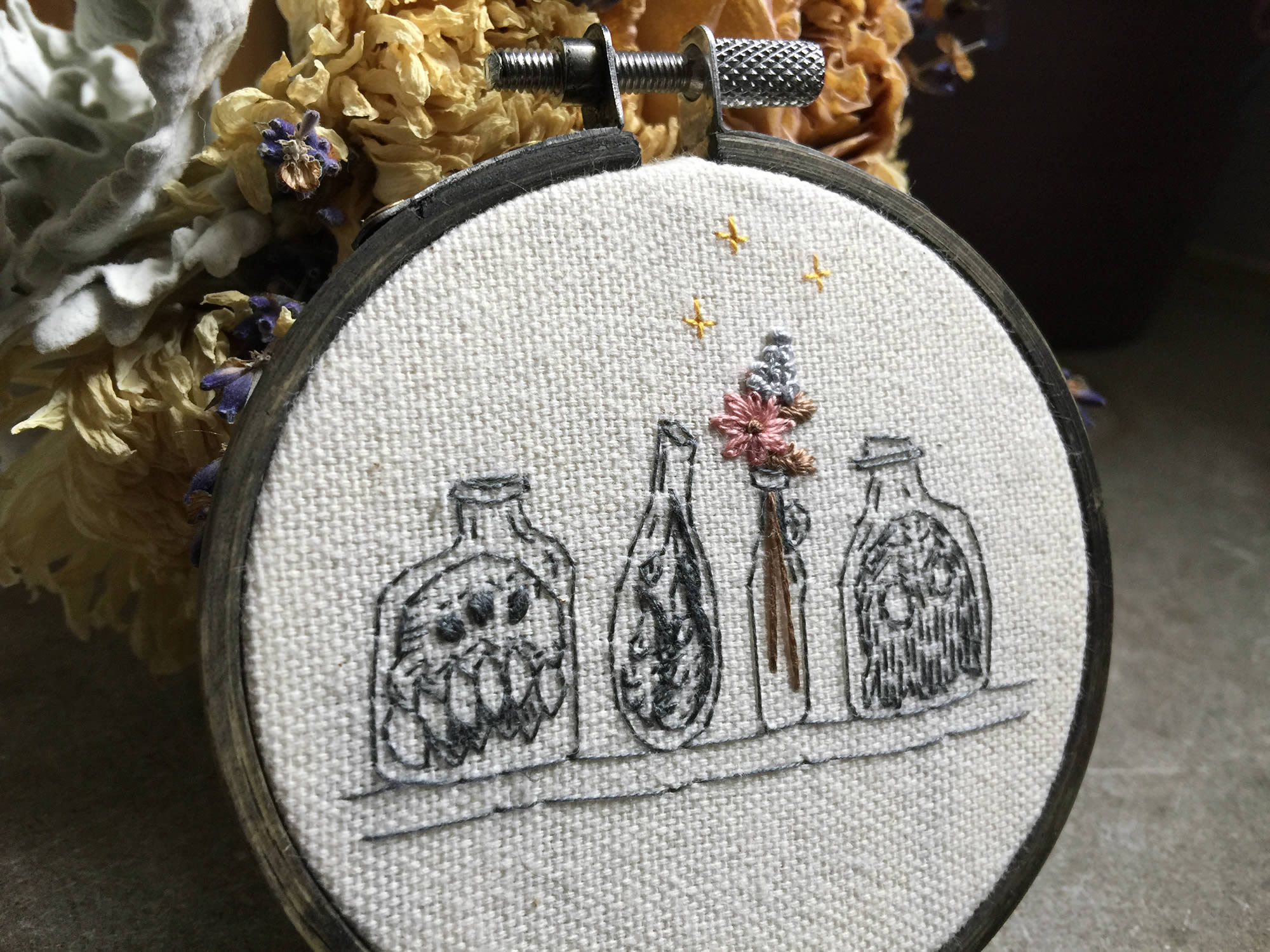 closeup of skeletons in bottle, hoop art