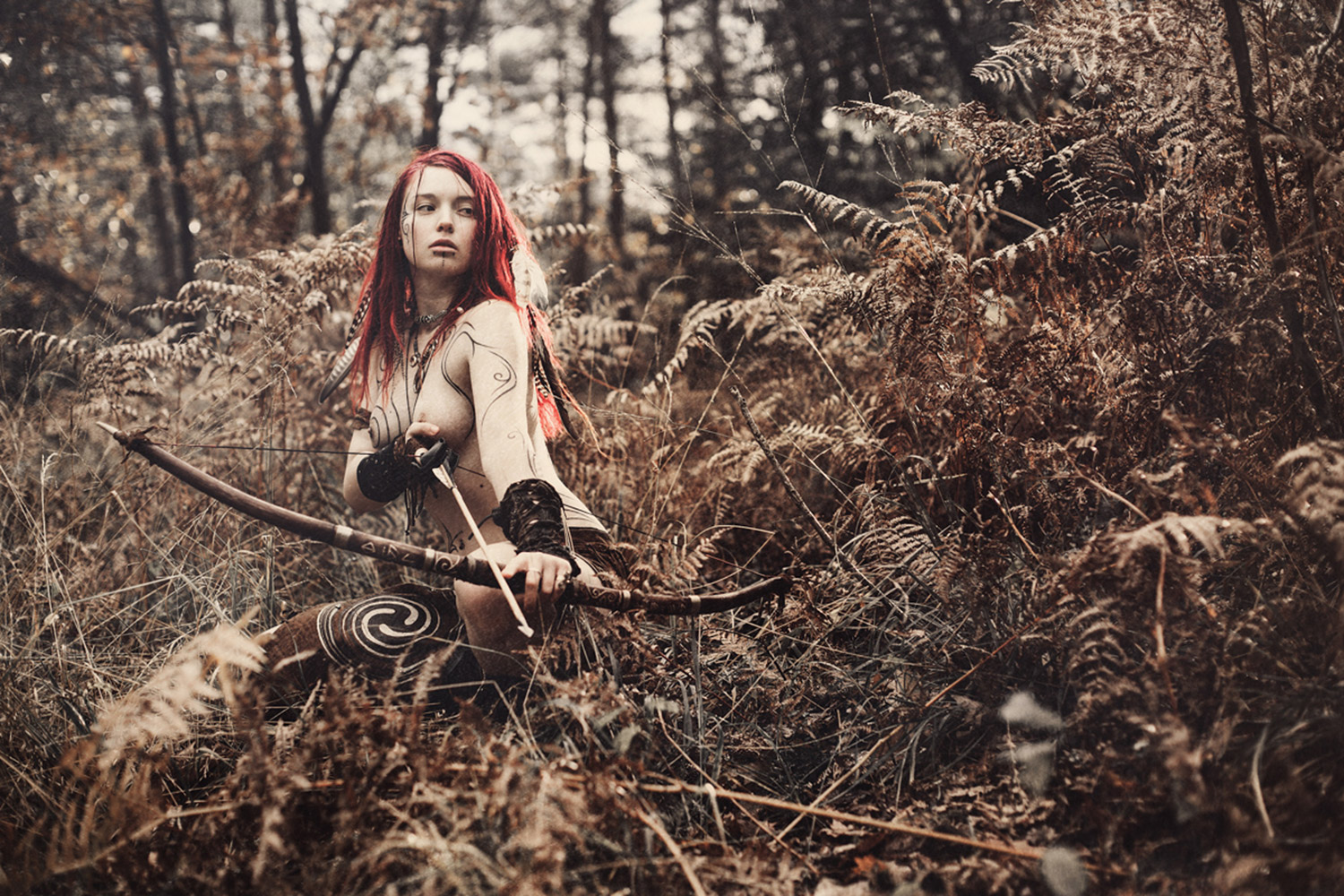 Charlotte Grimm - model Sam crouching with bow and arrow