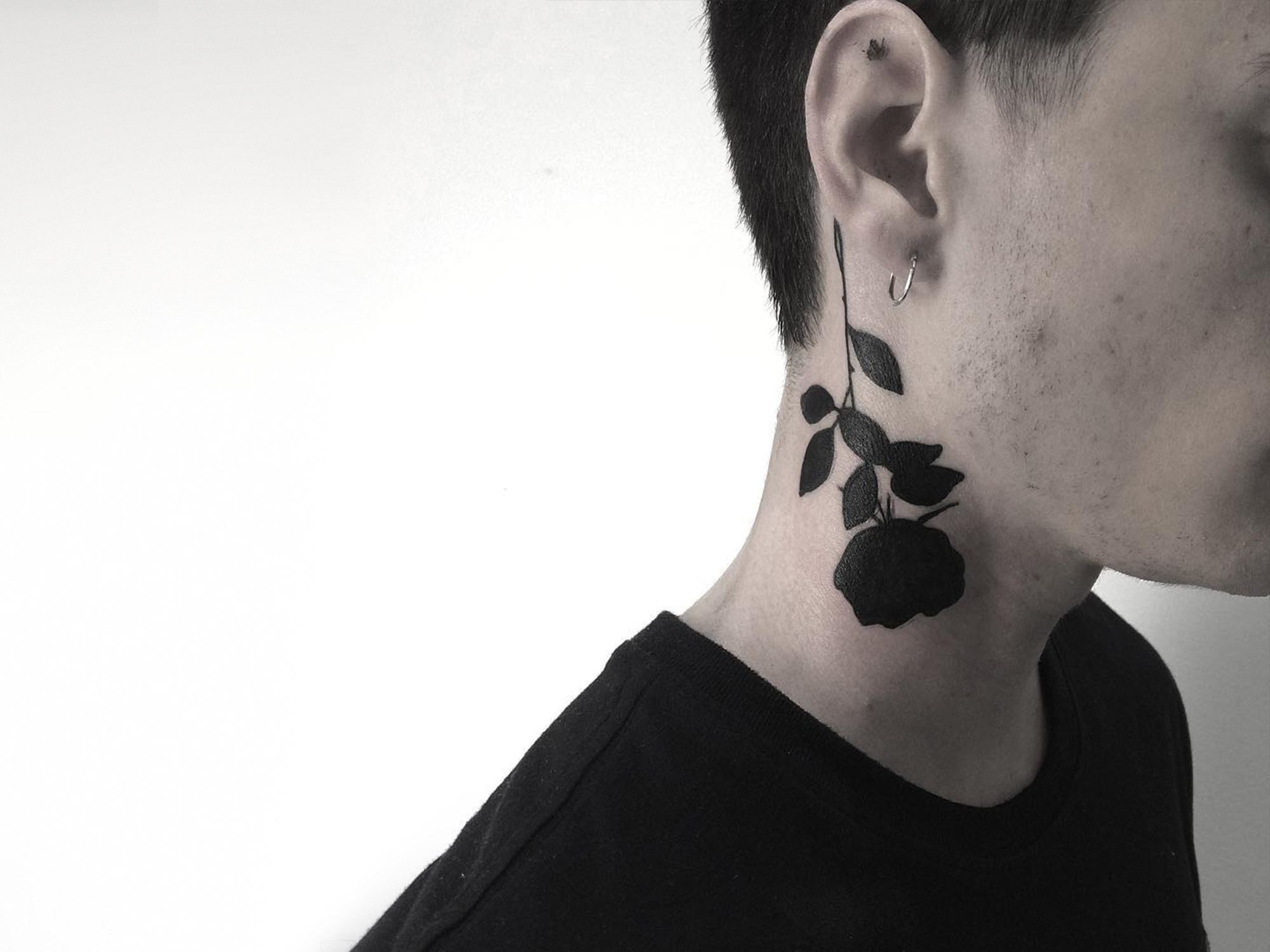 black rose tattoo on neck