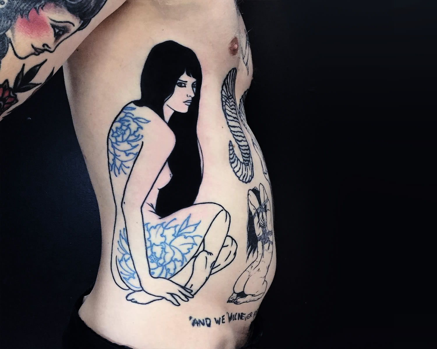 tattoo of a woman with blue (flowery) tattoos, side of body