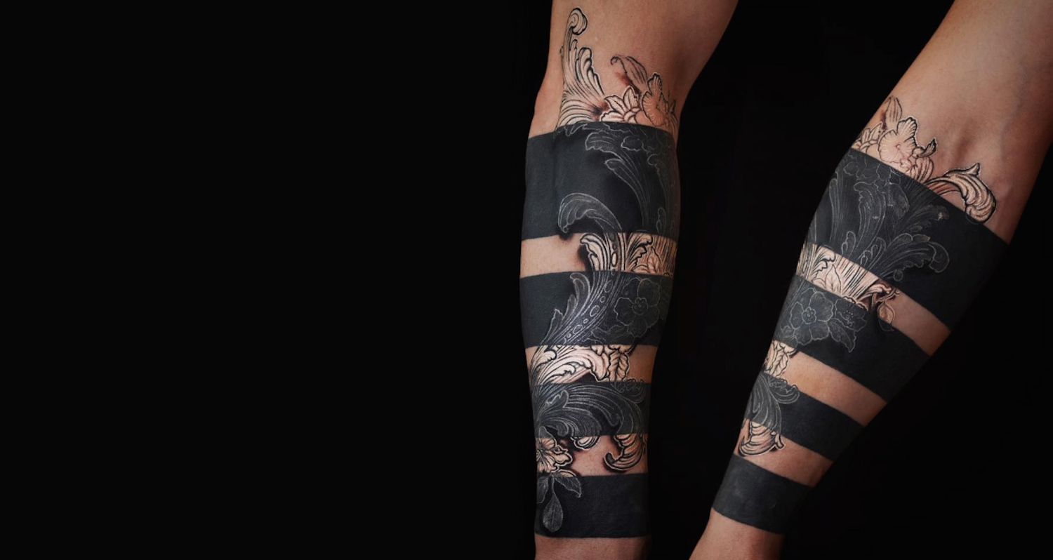 white ink on black tattoo