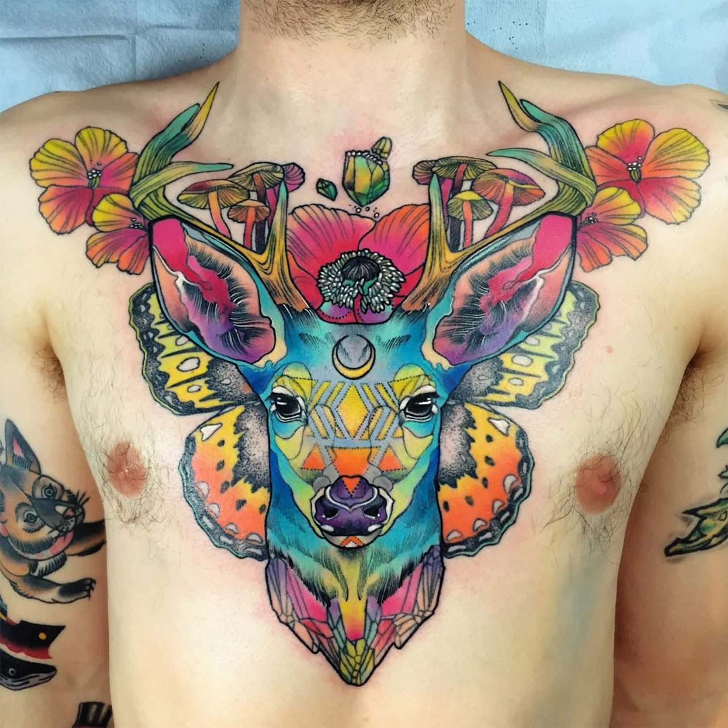 colored deer tattoo on chest