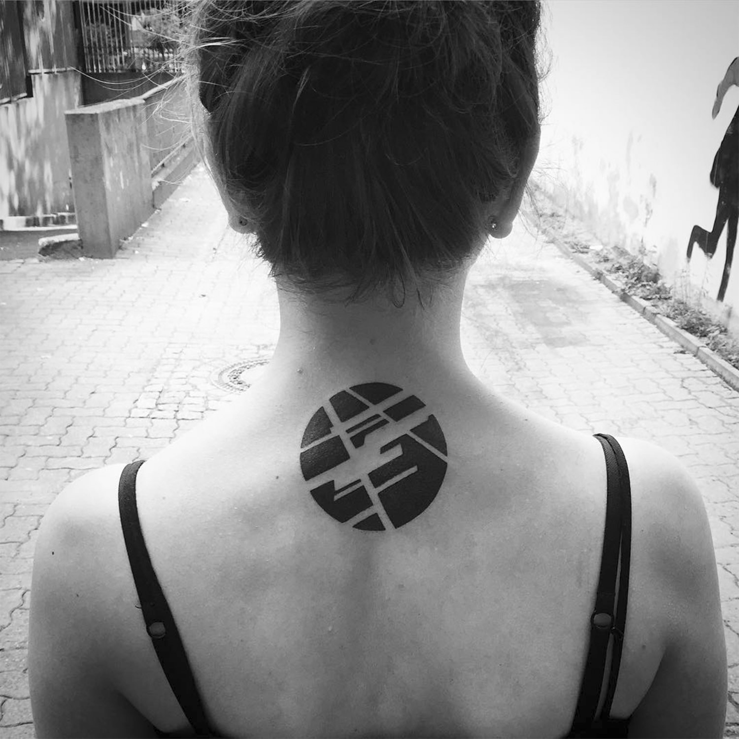 circle tattoo on back of neck