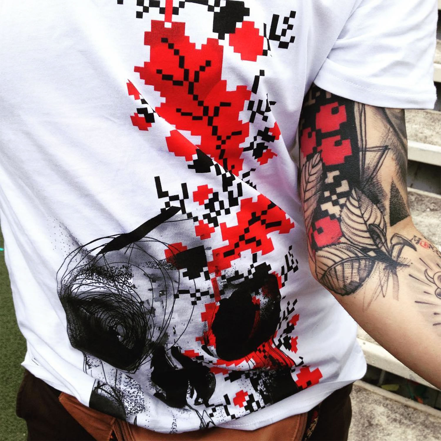 tshirt and red and black tattoo on arm