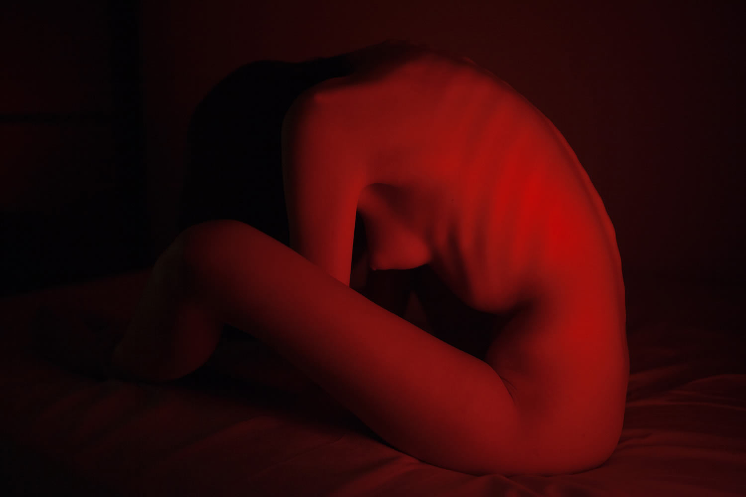 red lighting over nude body