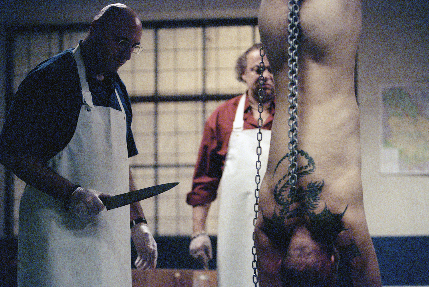 butcher with knife, man hanged upside down, in pusher 1996