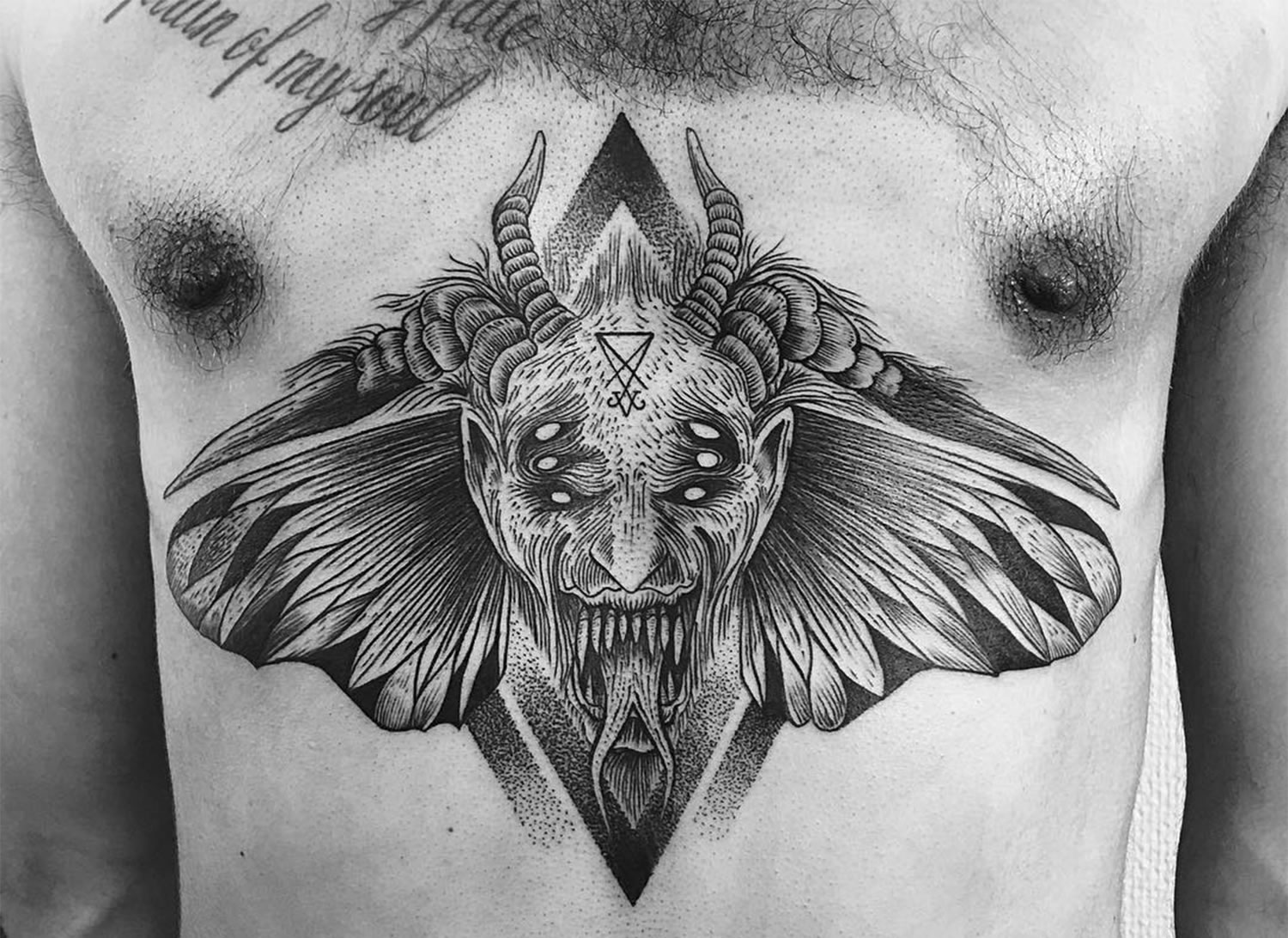 devil moth tattoo on chest