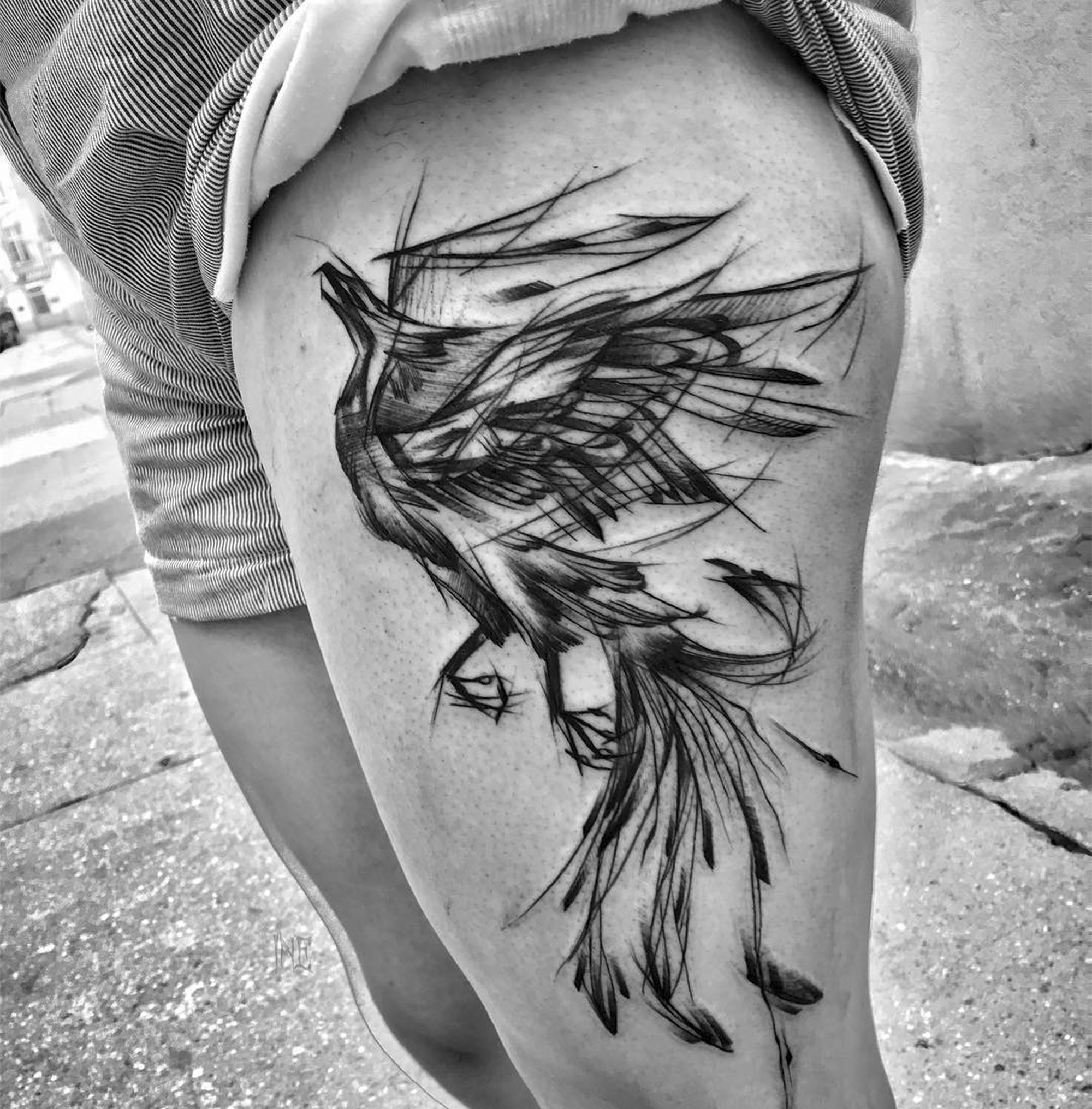 expressive bird tattooed on thigh