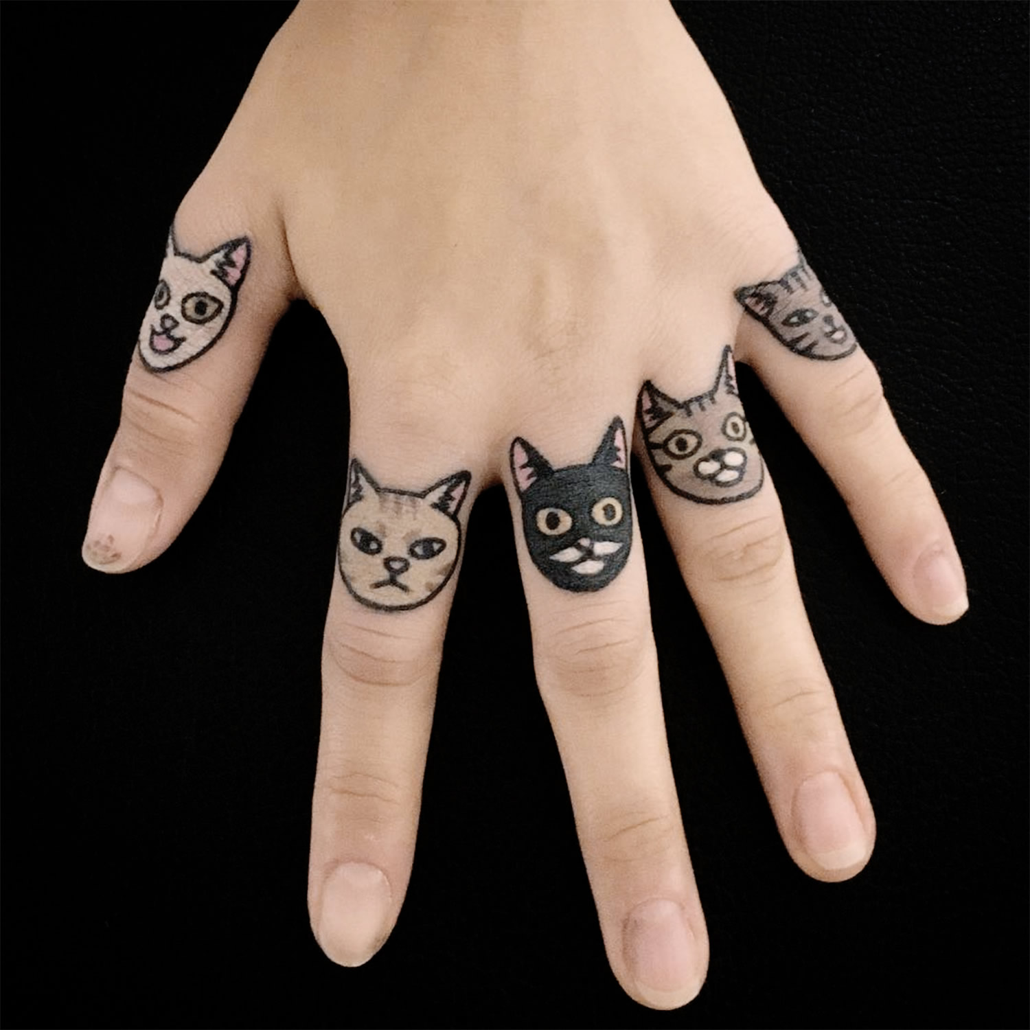cat tattoos on each finger, hand tattoo