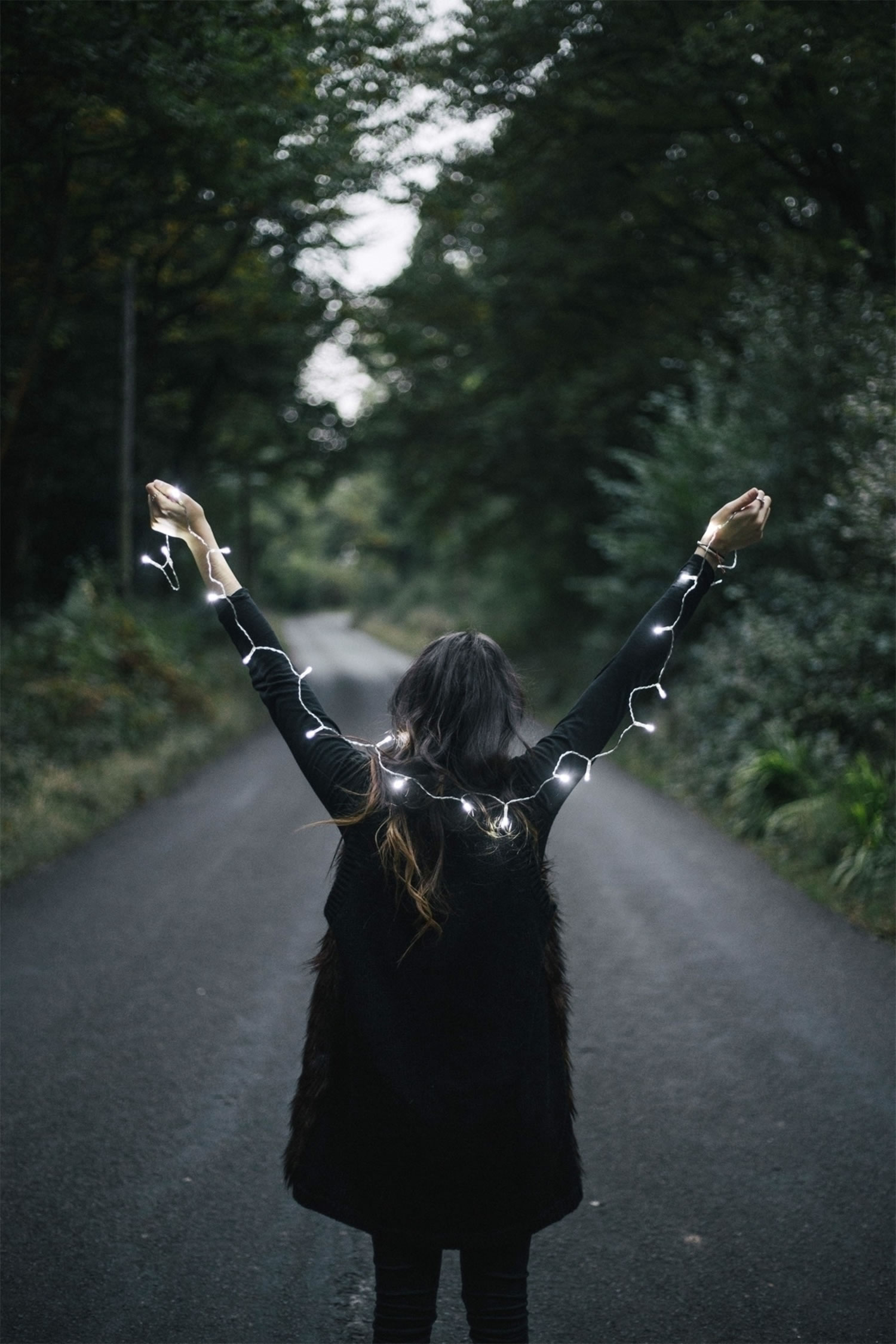 woman holding christmas lights. photography by dom rees