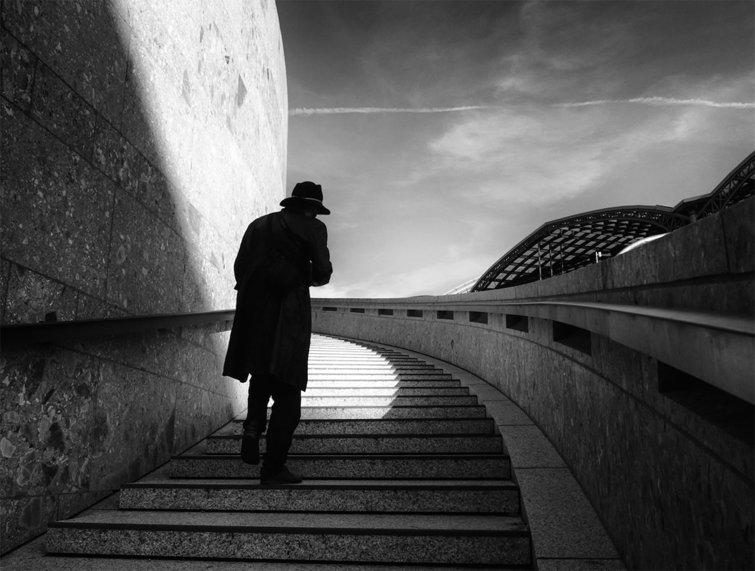 mysterious man on walking up stairs, black and white, by Georgie Pauwels