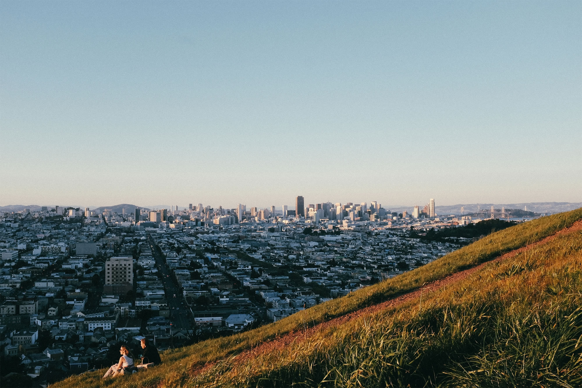 group of people viewing sunrise over city, photo by israel sundseth