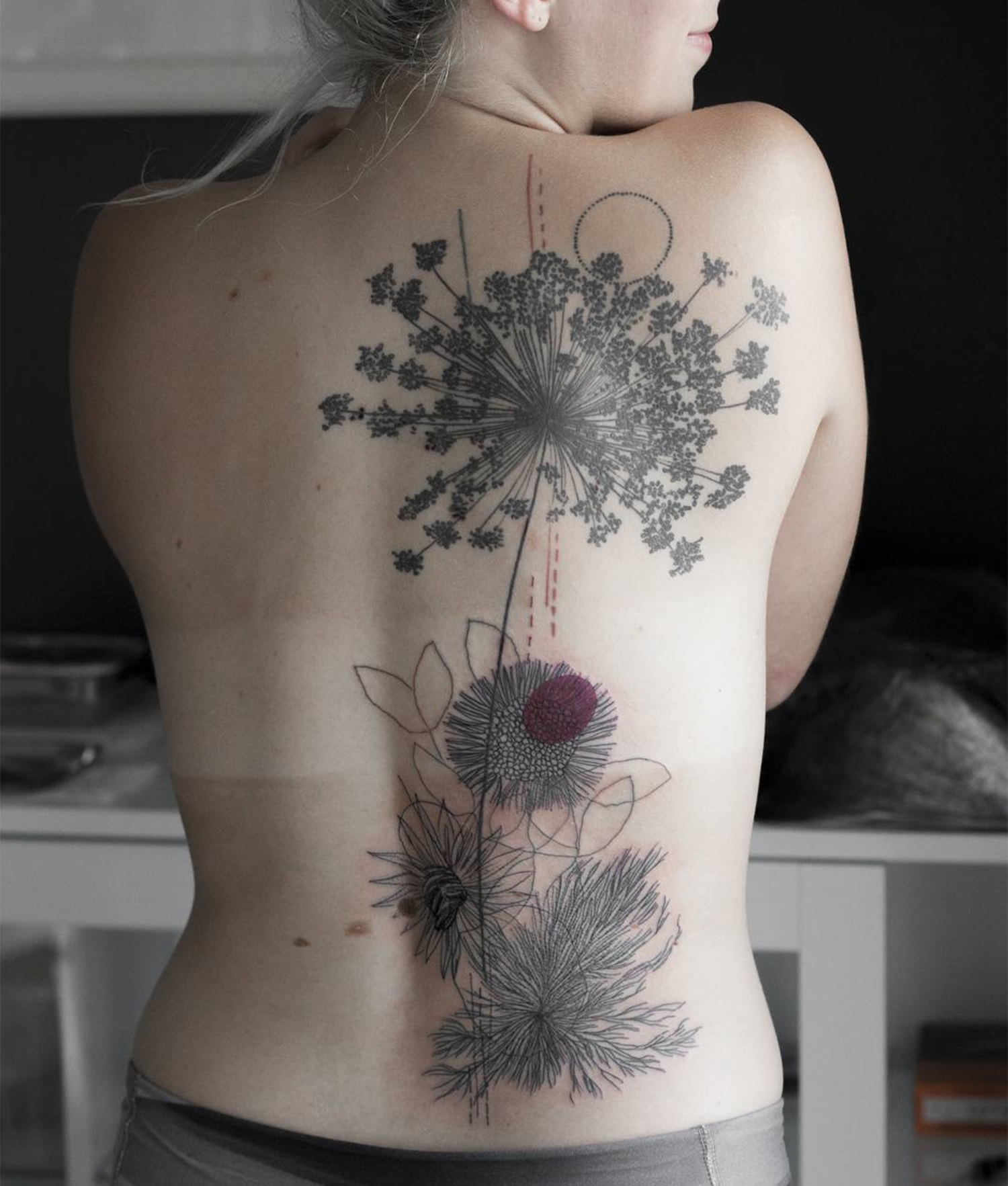 sketchy flower tattoo on back