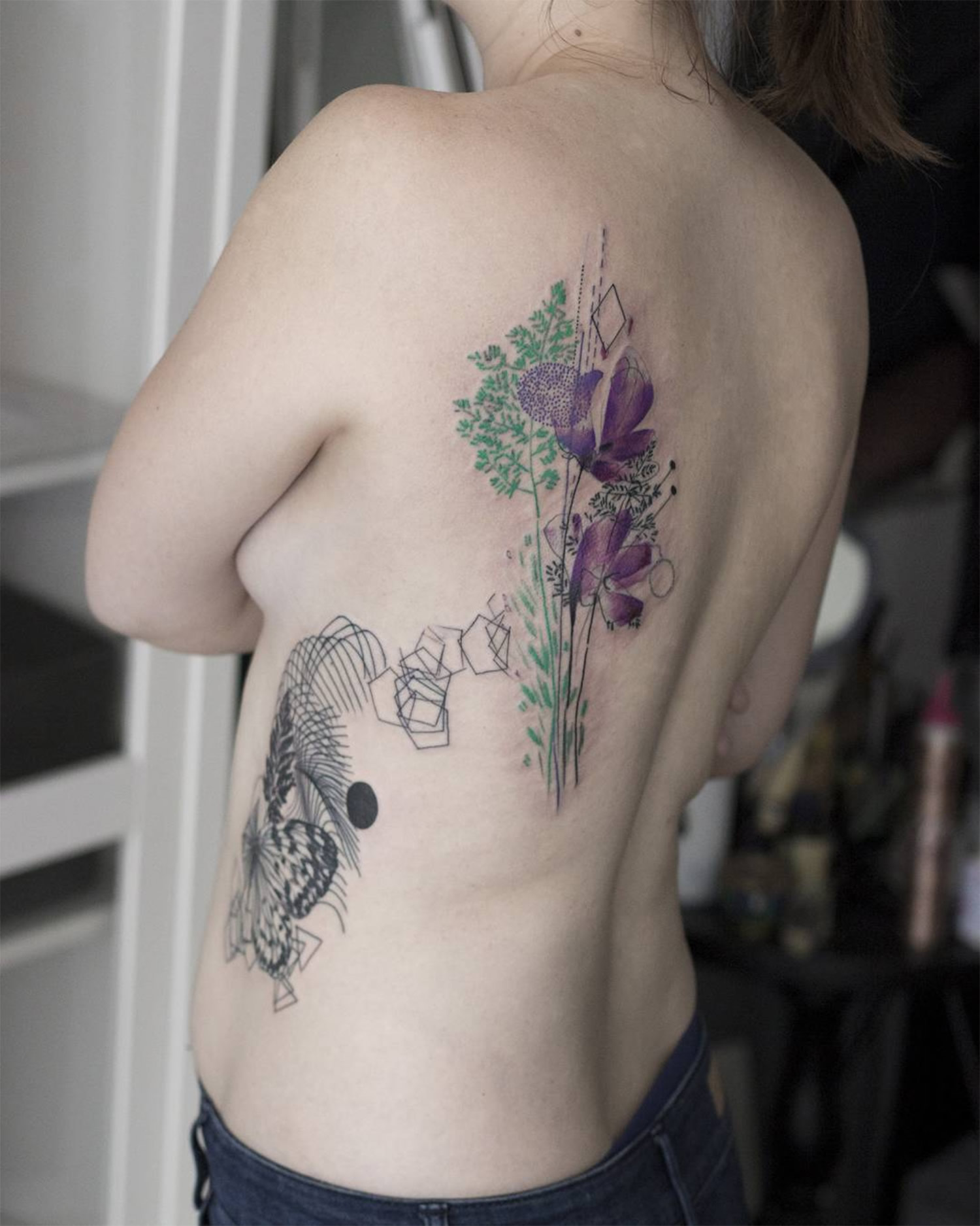 flower tattoo on ribs and back