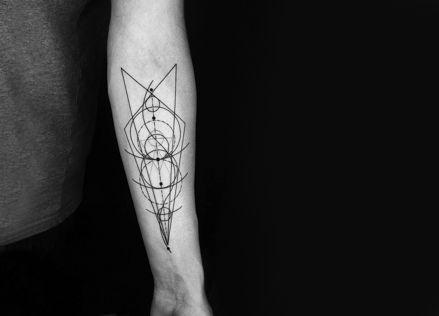 geometric line tattoo on inner arm