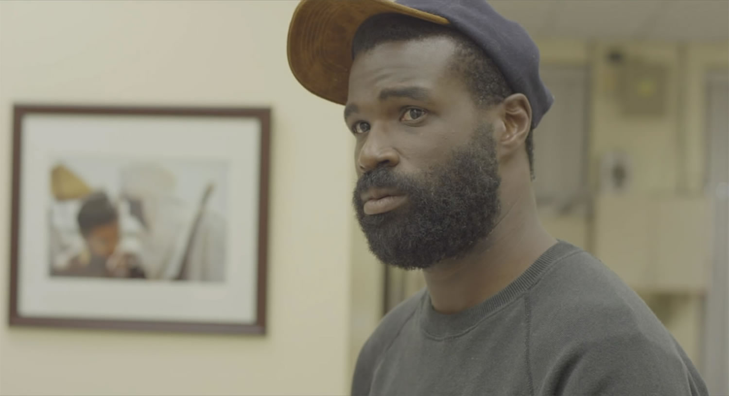 man with baseball hat in nasty baby