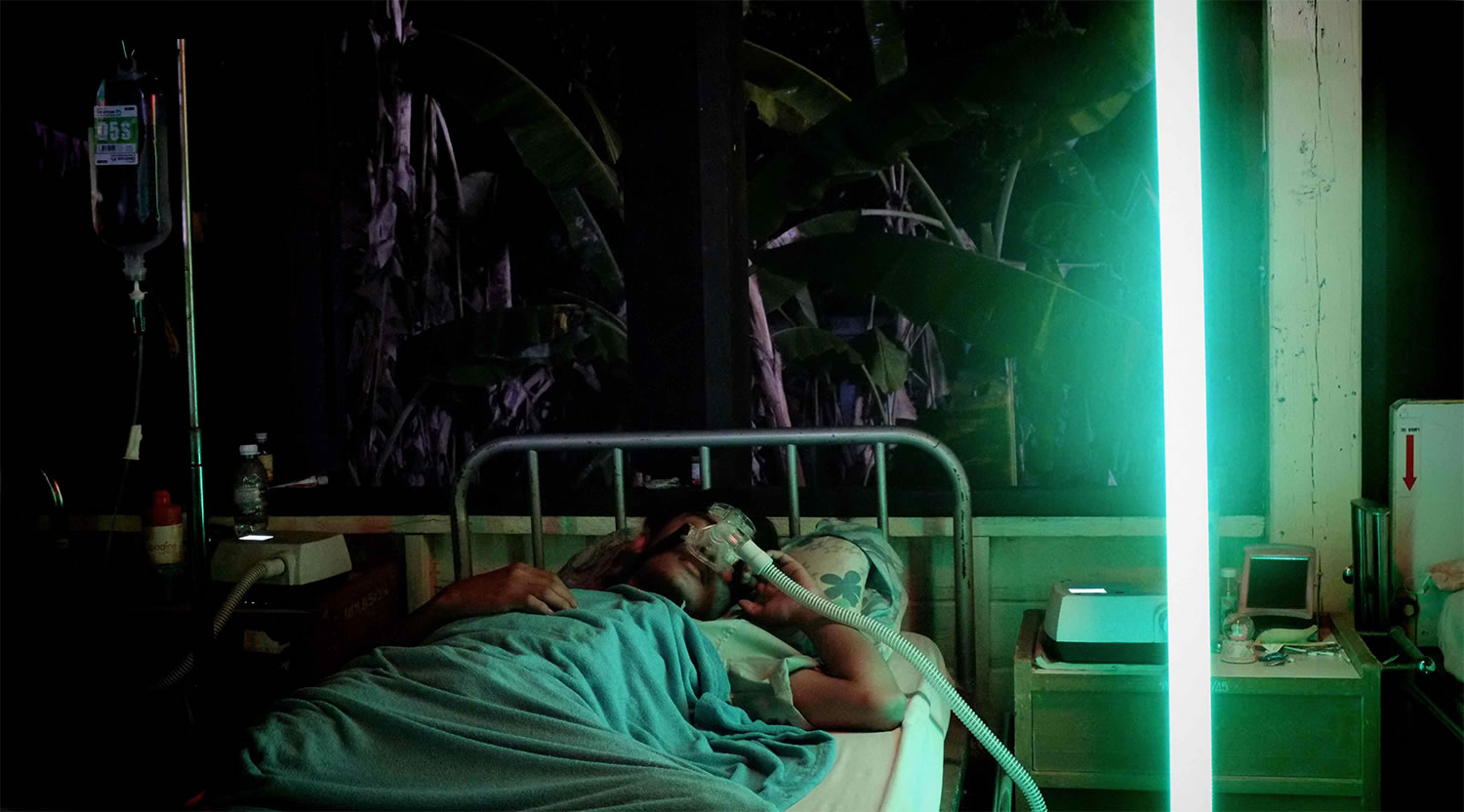 patient in sick bed, neon lights in cemetery of splendour