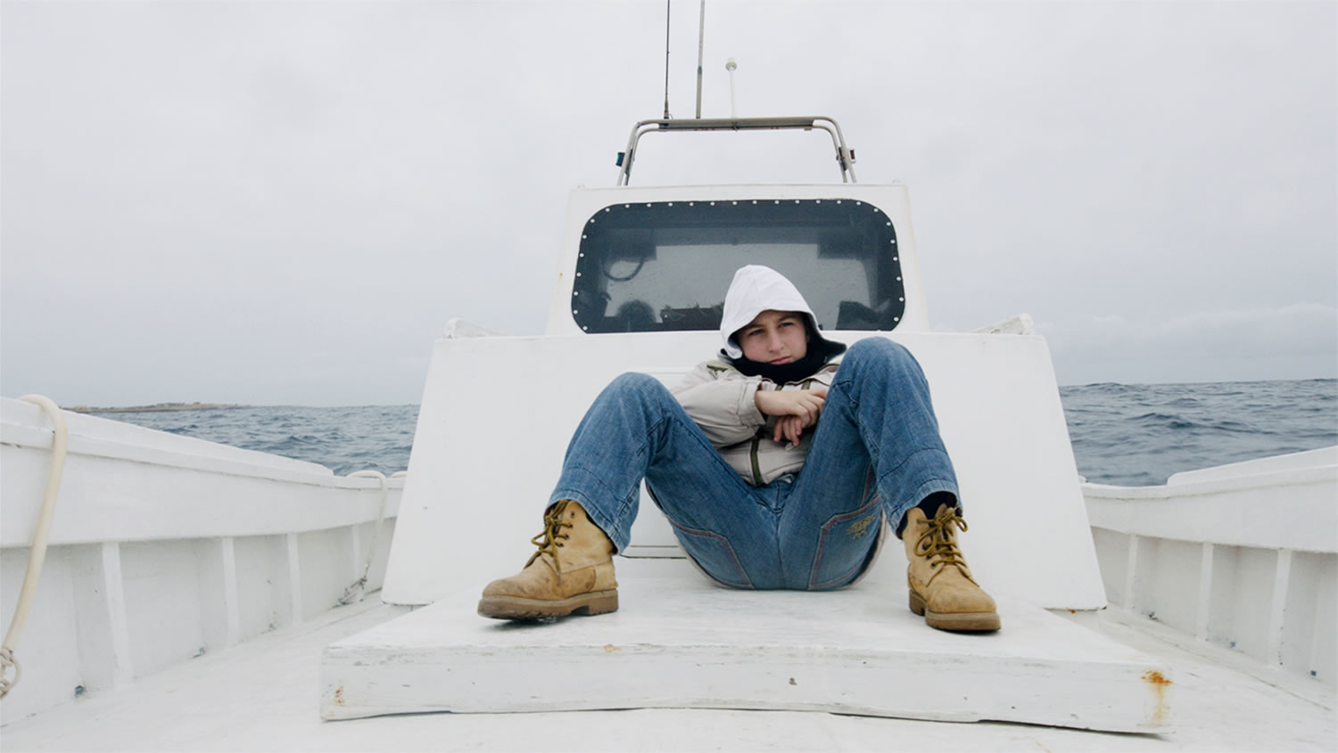 boy on boat, fire at sea