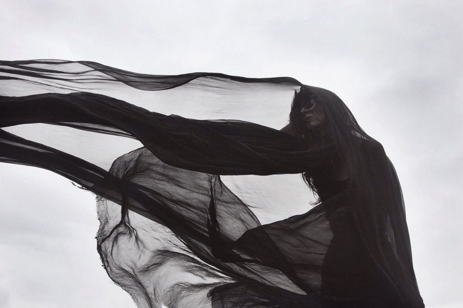 Nona Limmen - black veil with outstretched arm