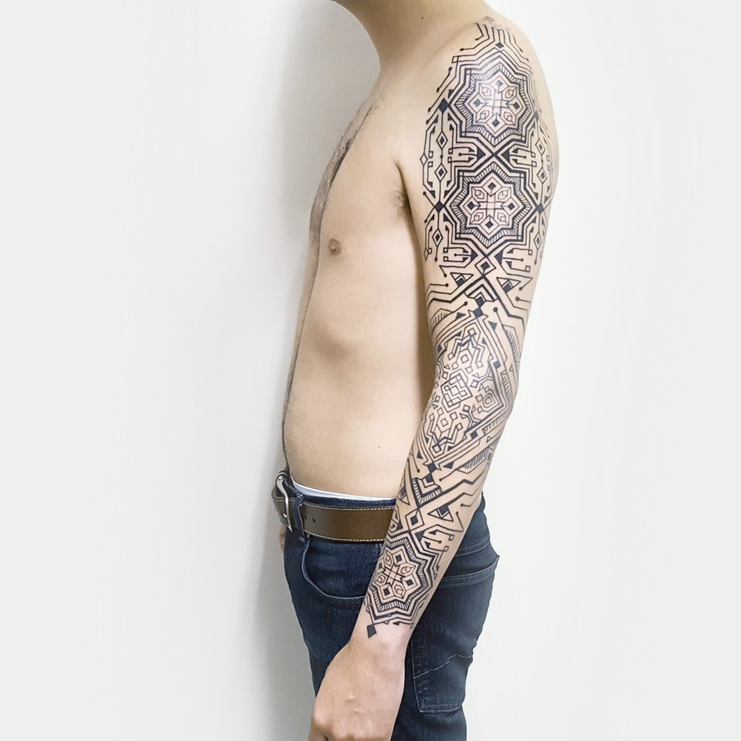 geometric shapes, tattoo on arm, black ink