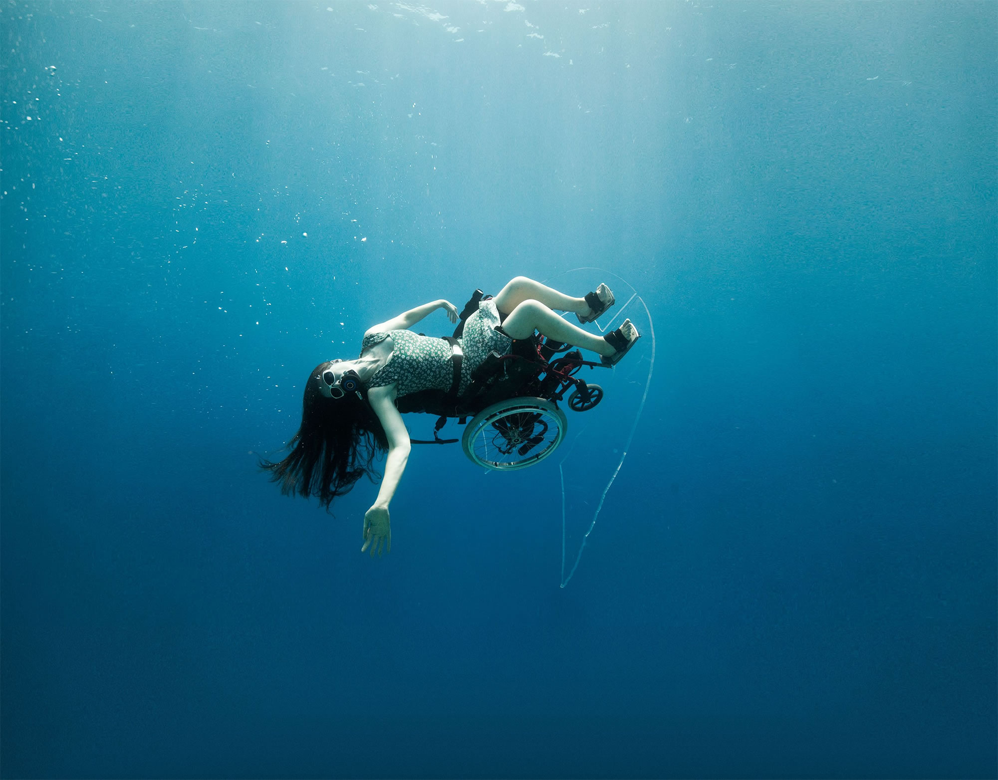 woman sitting in wheelchair, underwater photography, by sue austin