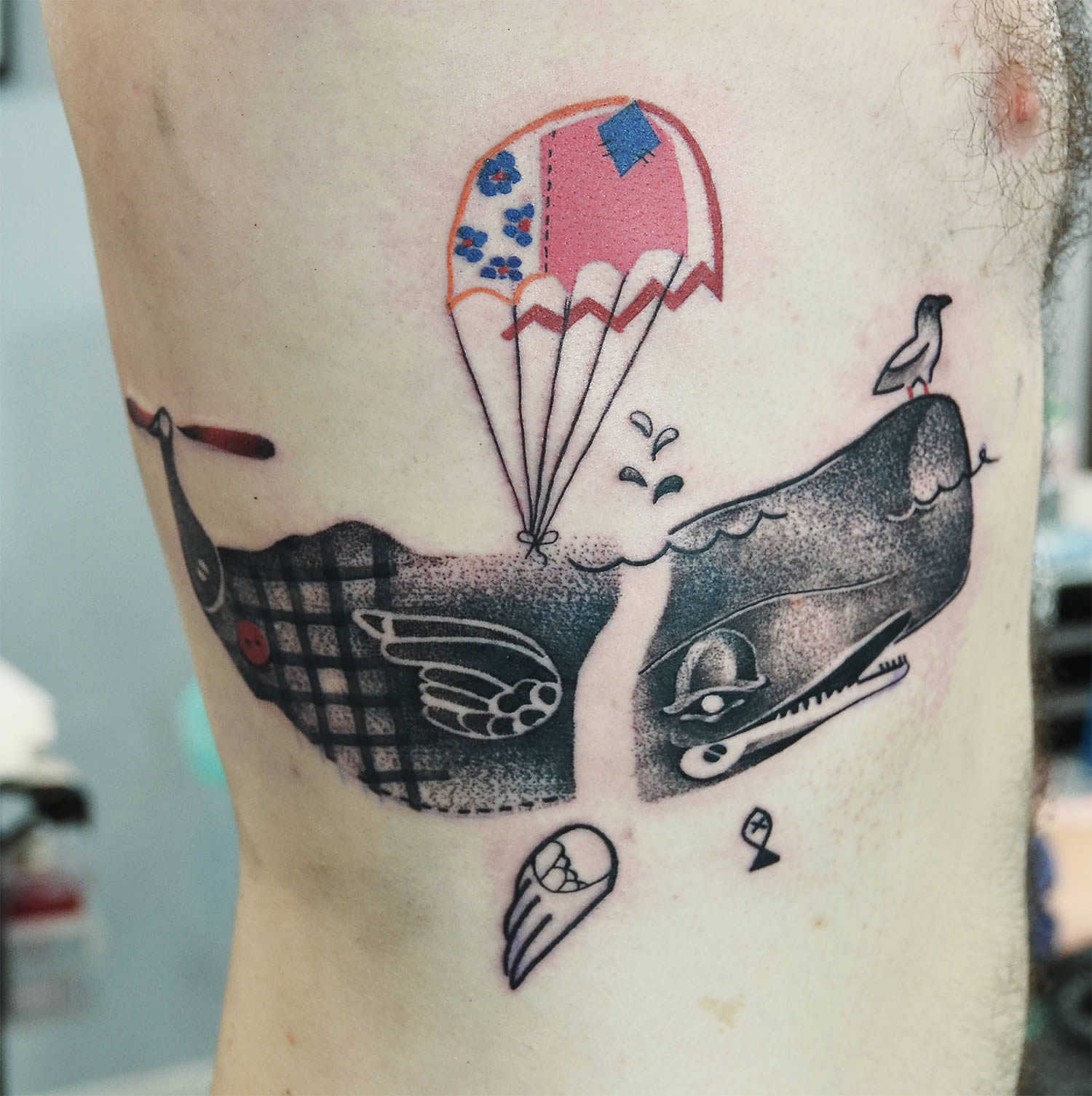 whale with parachute tattoo, ribs