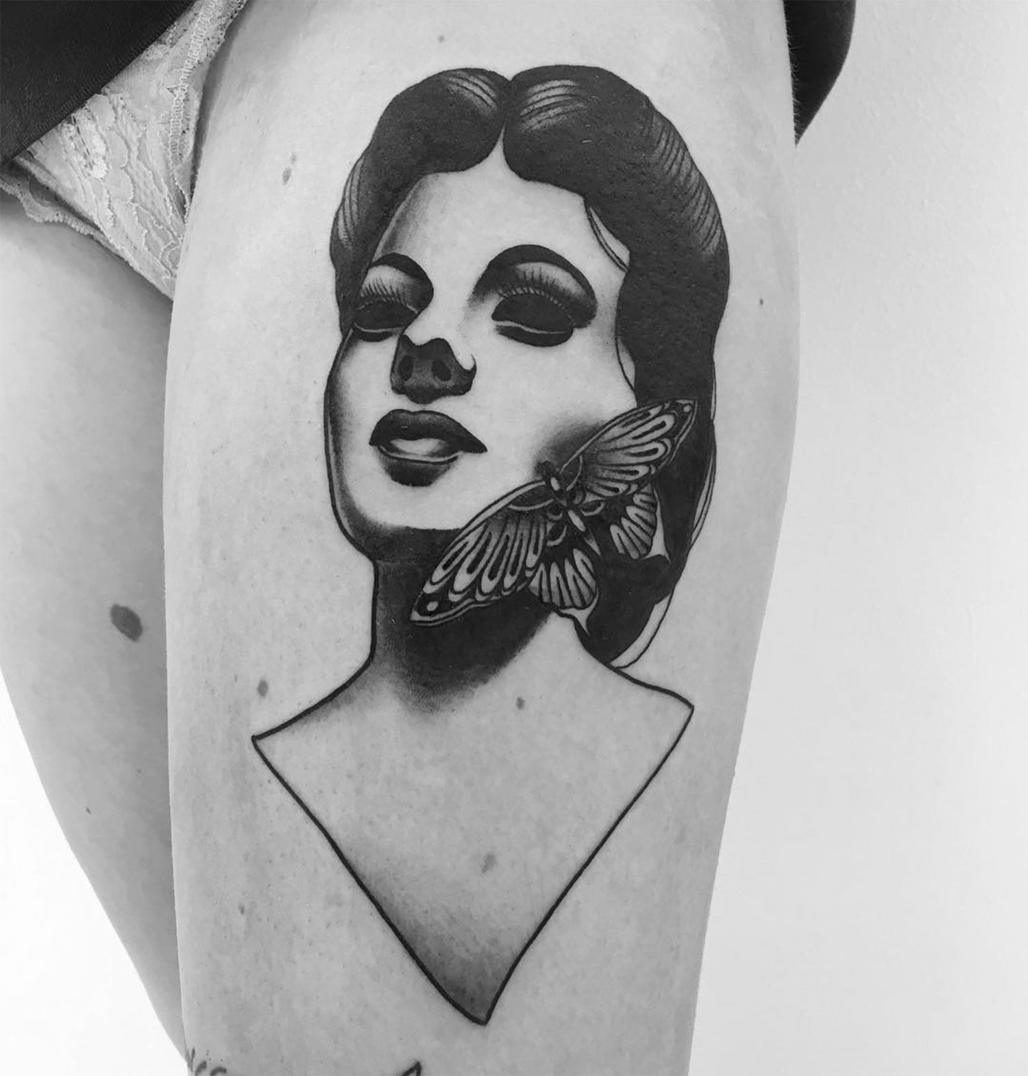woman portrait tattoo on thigh