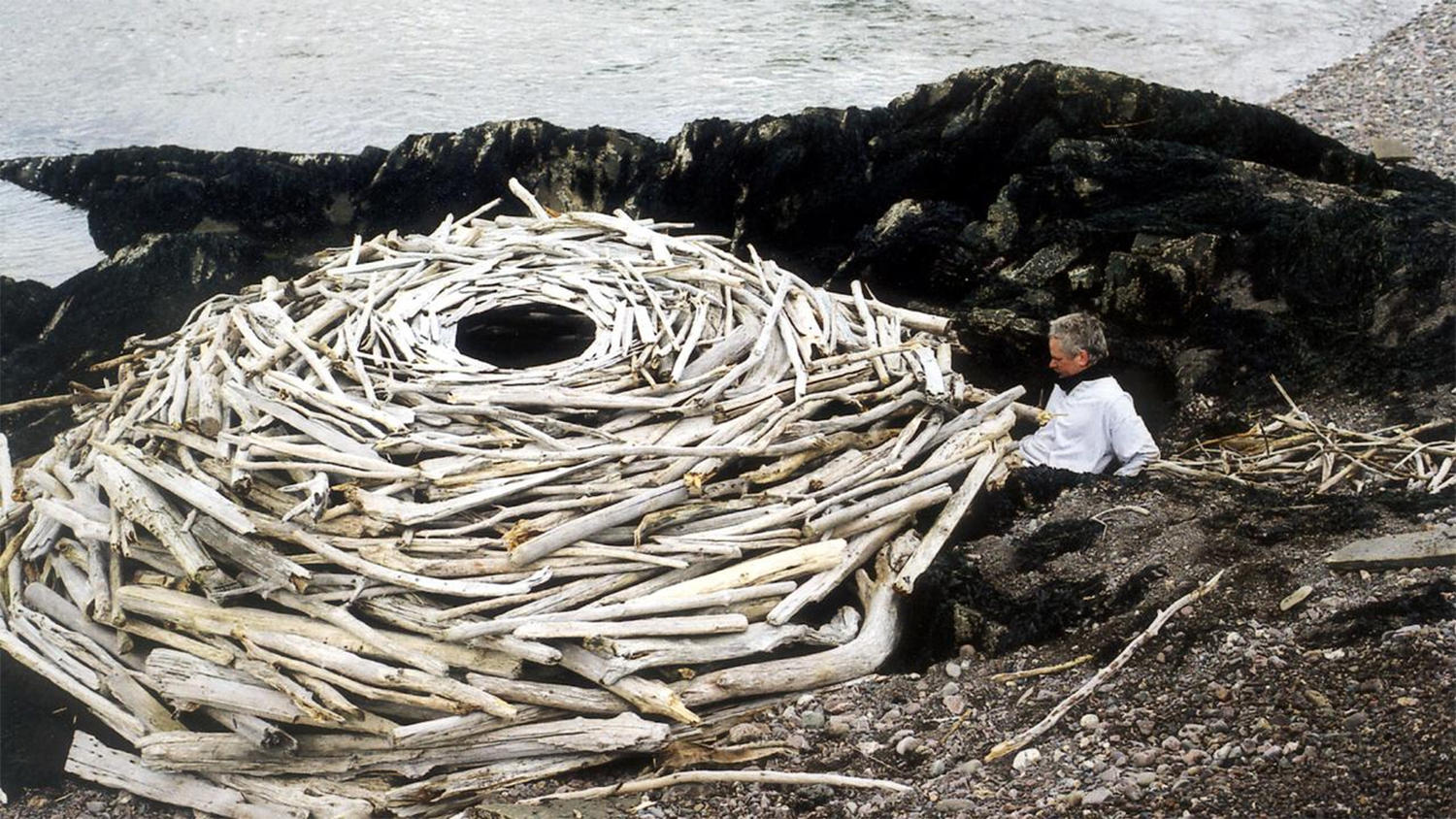 Andy Goldsworthy working on an environmental art piece