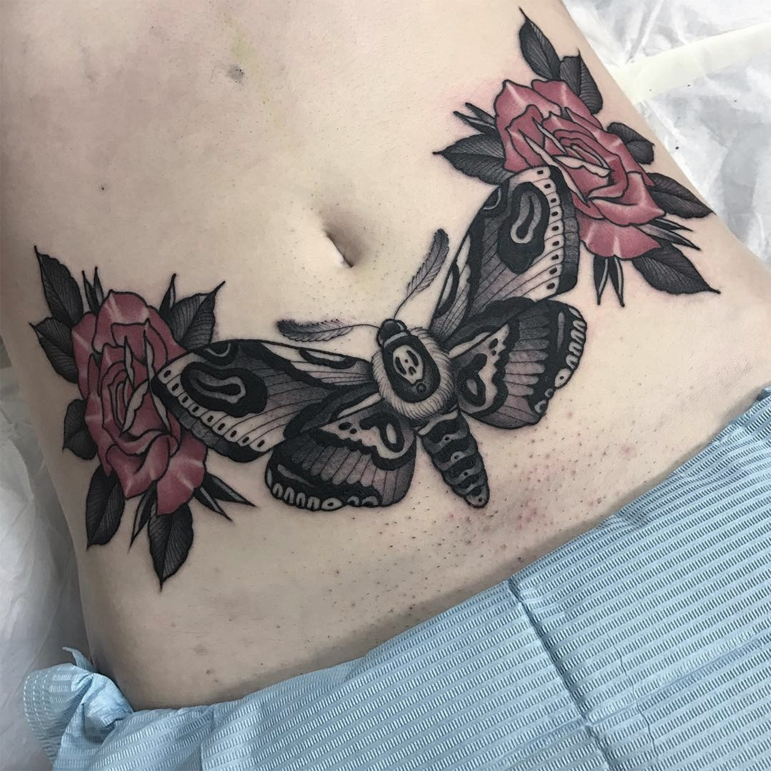 traditionell stil moth and roses tattoo on belly, by Jean Le Roux