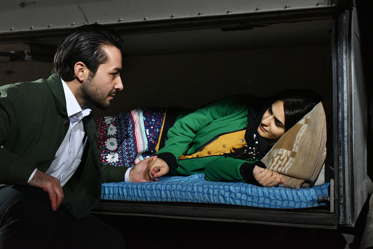 man talking to a woman lying on train bed, The Other Side of Hope