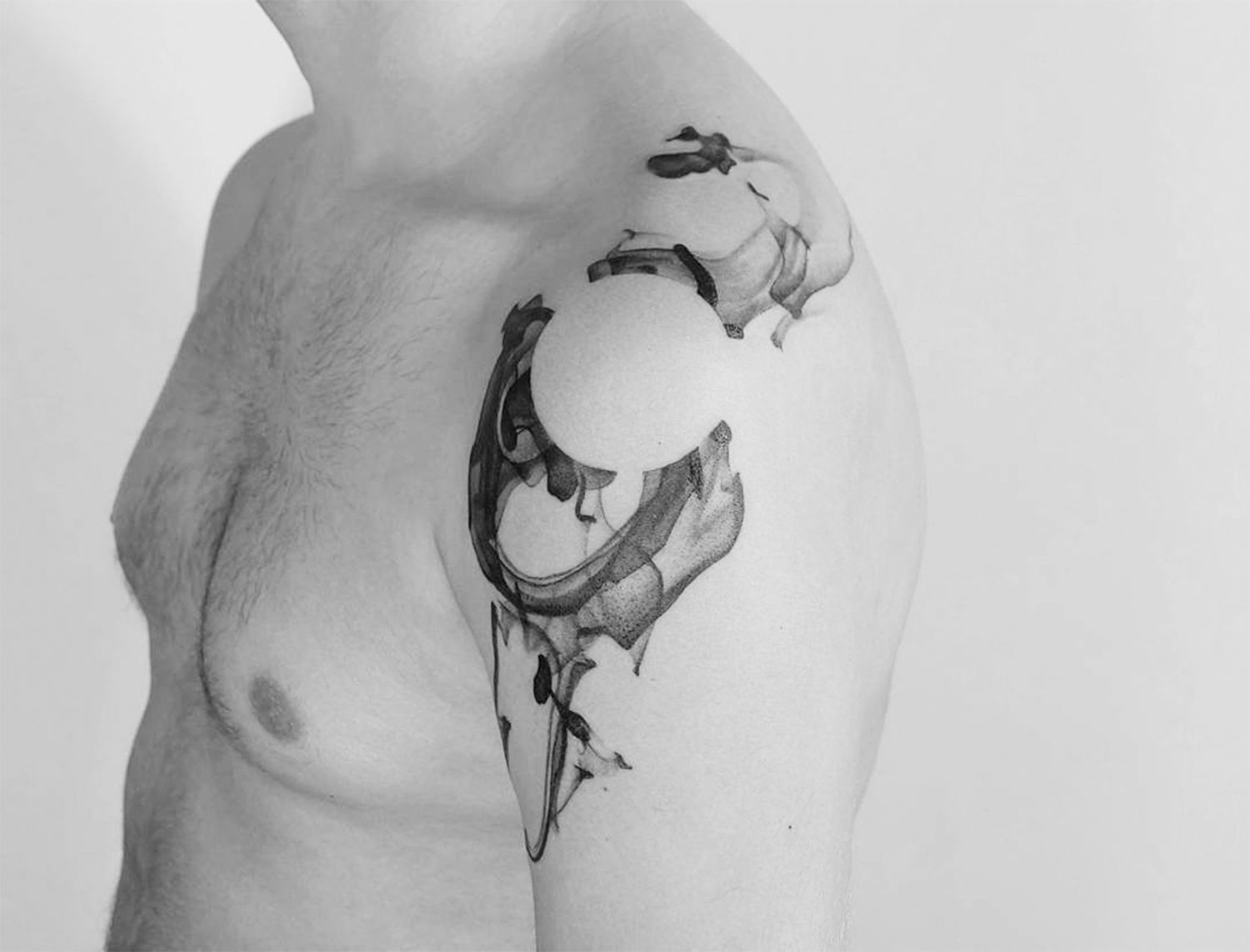 paintbrush style tattoo, negative space circle on shoulder by Roman Melnikov