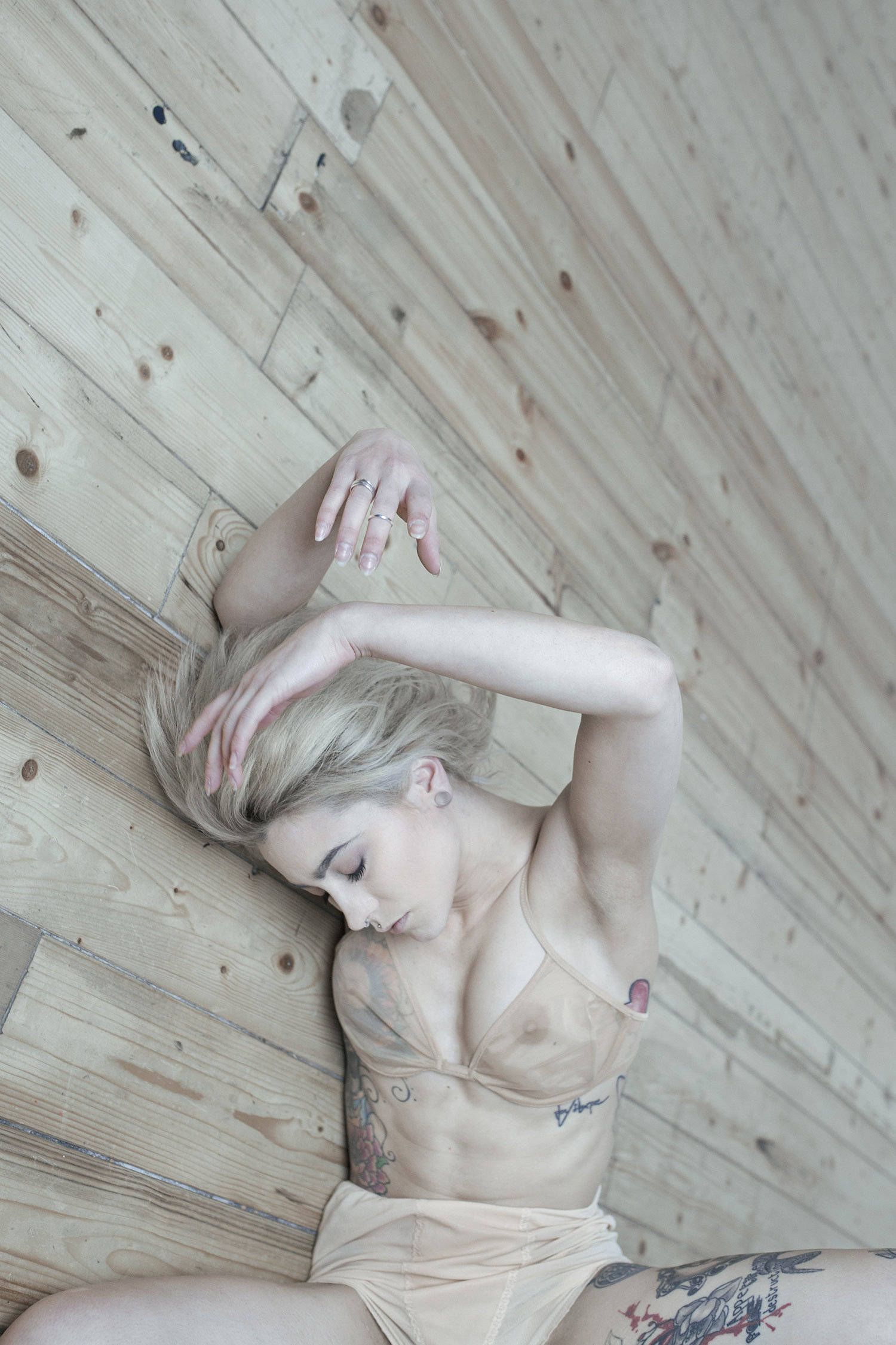 woman and bra, lying on floor