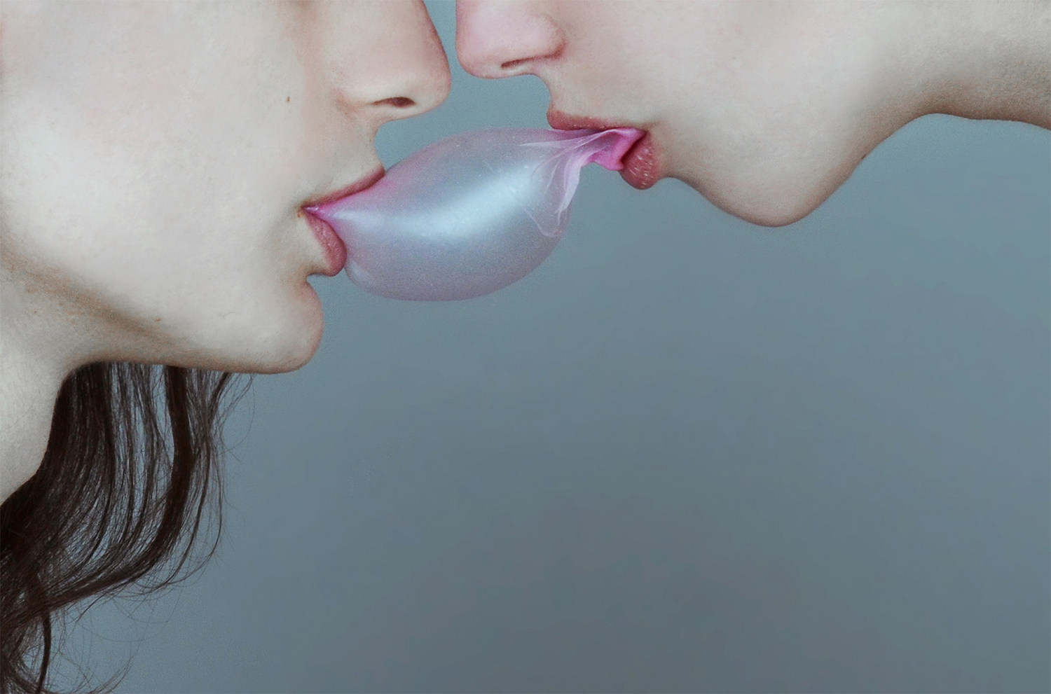 girls holding on to bubblegum with lips, photography