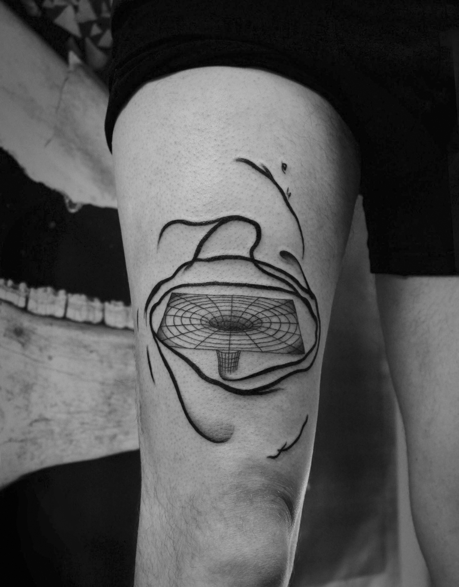 abstract lines and vortex, tattoo on thigh