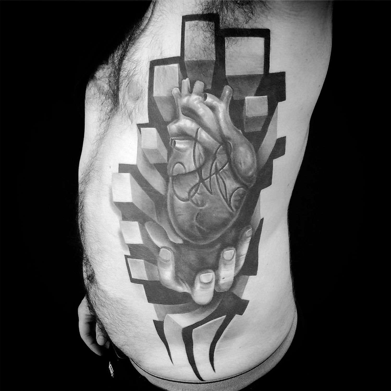 hand holding heart tattoo