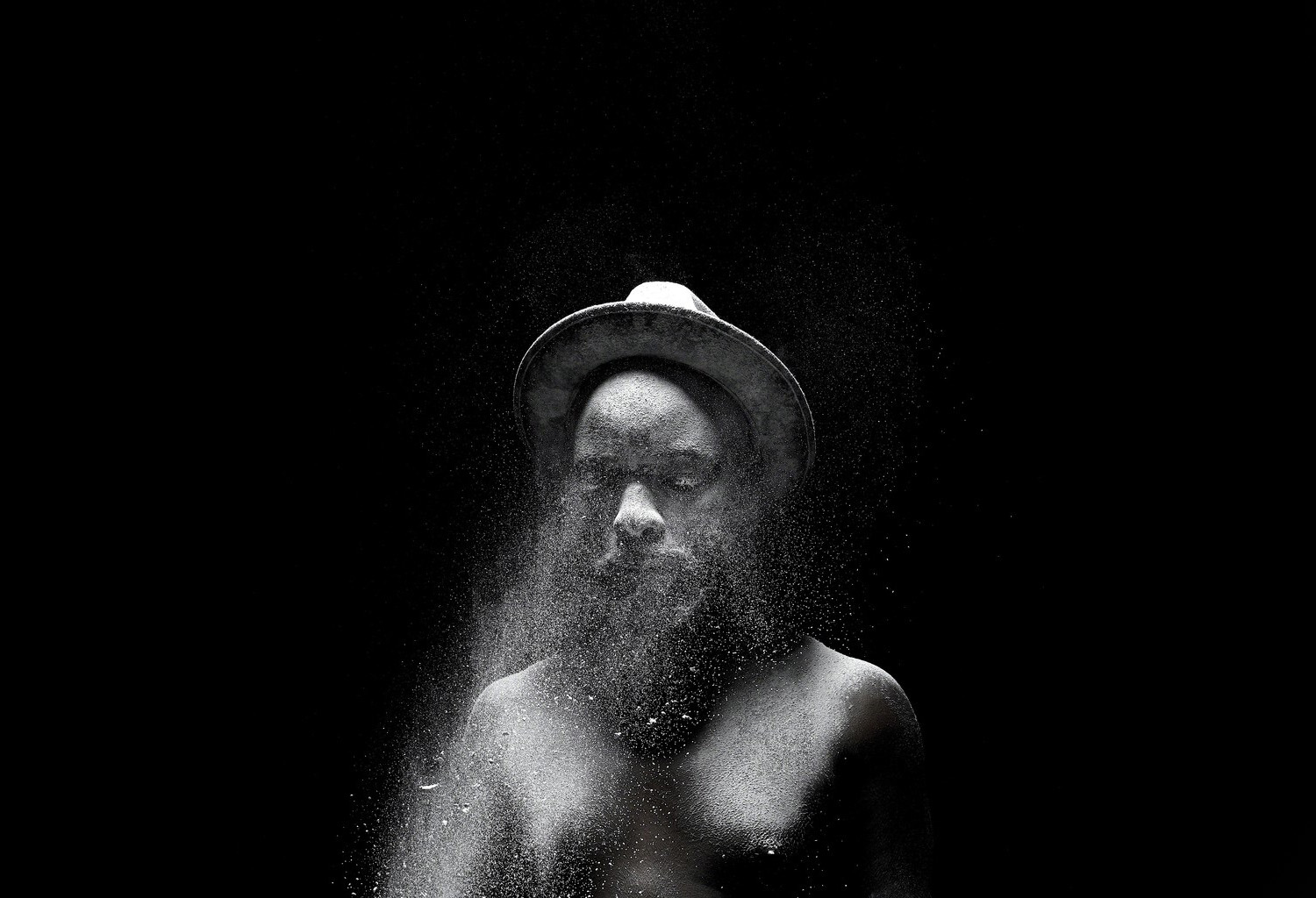 Man standing with splashes of water in his face