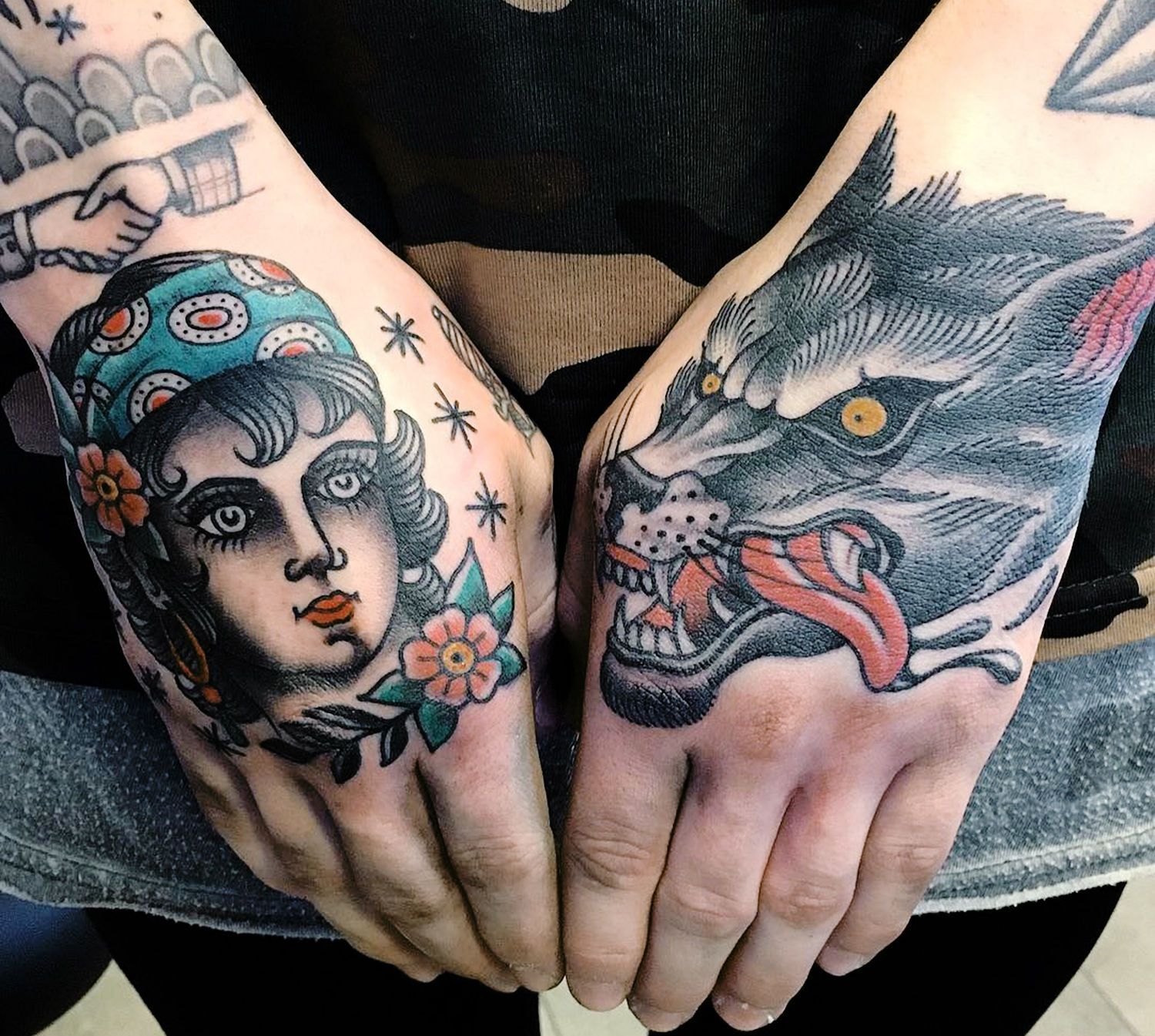 woman and wolf tattoo on hands