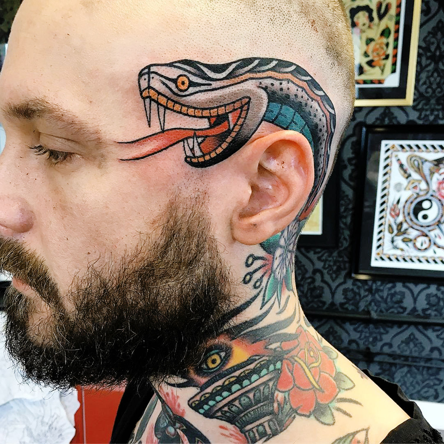 Snake tattoo on side of head, neotraditional