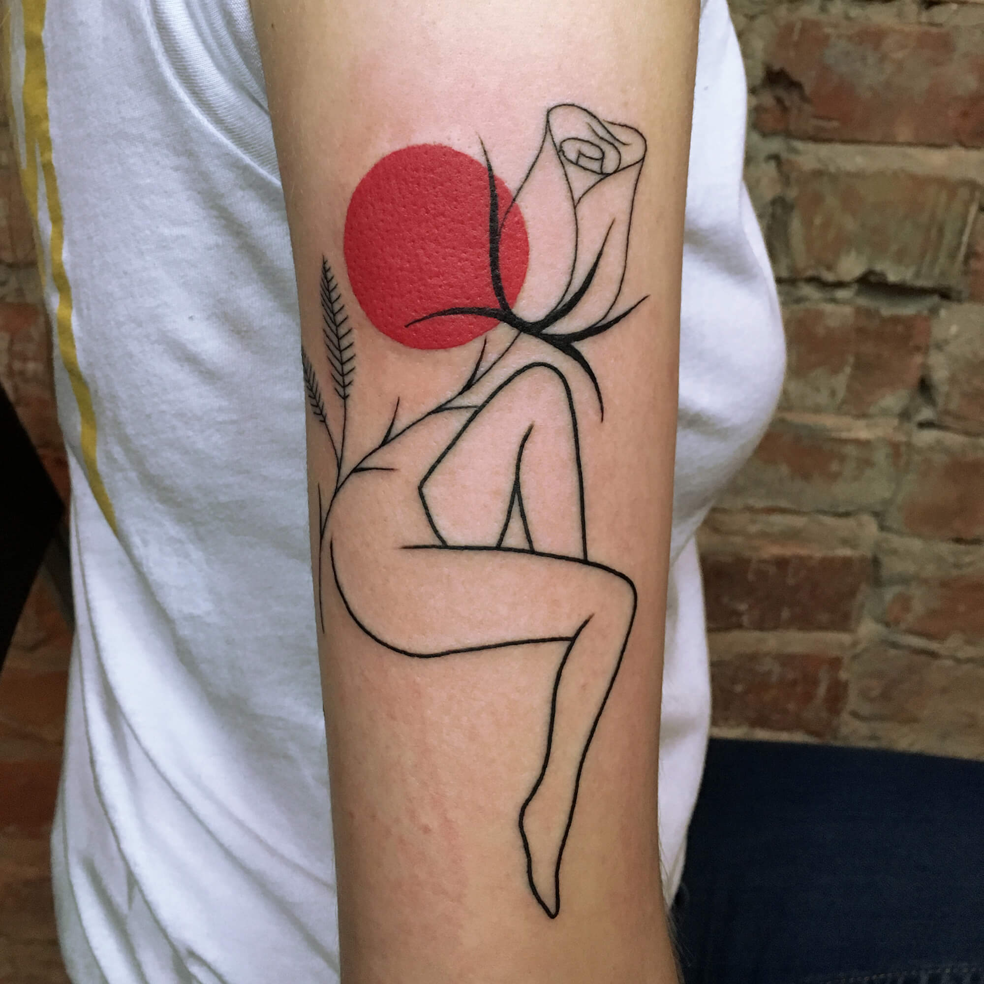 Line tattoo with red dot accent