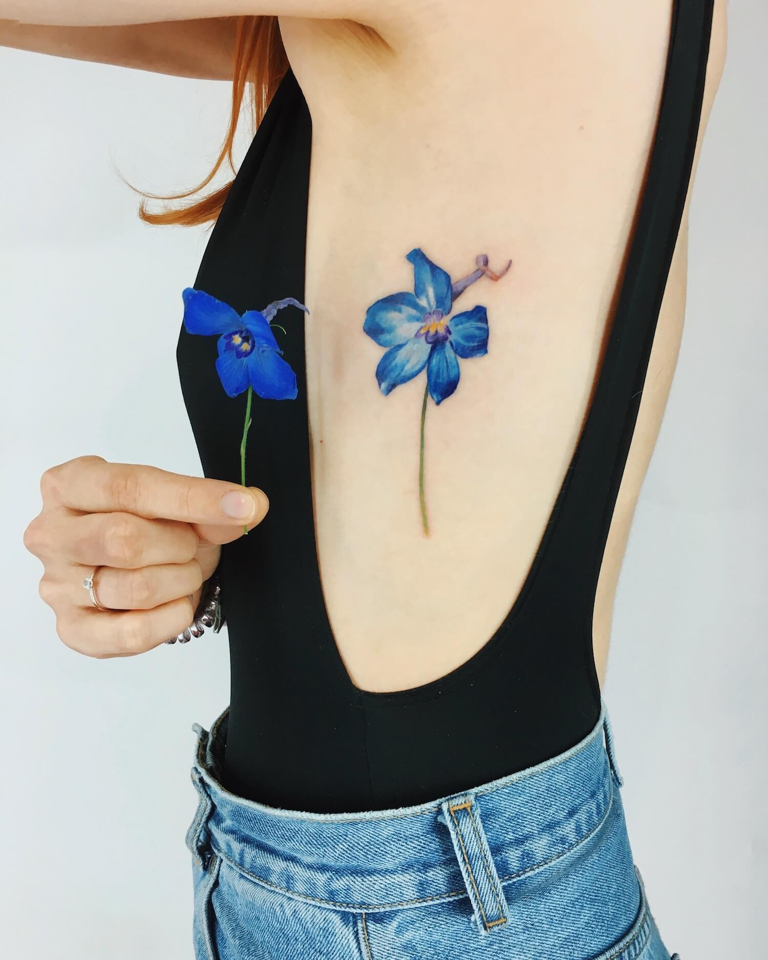 Flower tattoo on arm by Rit Kit