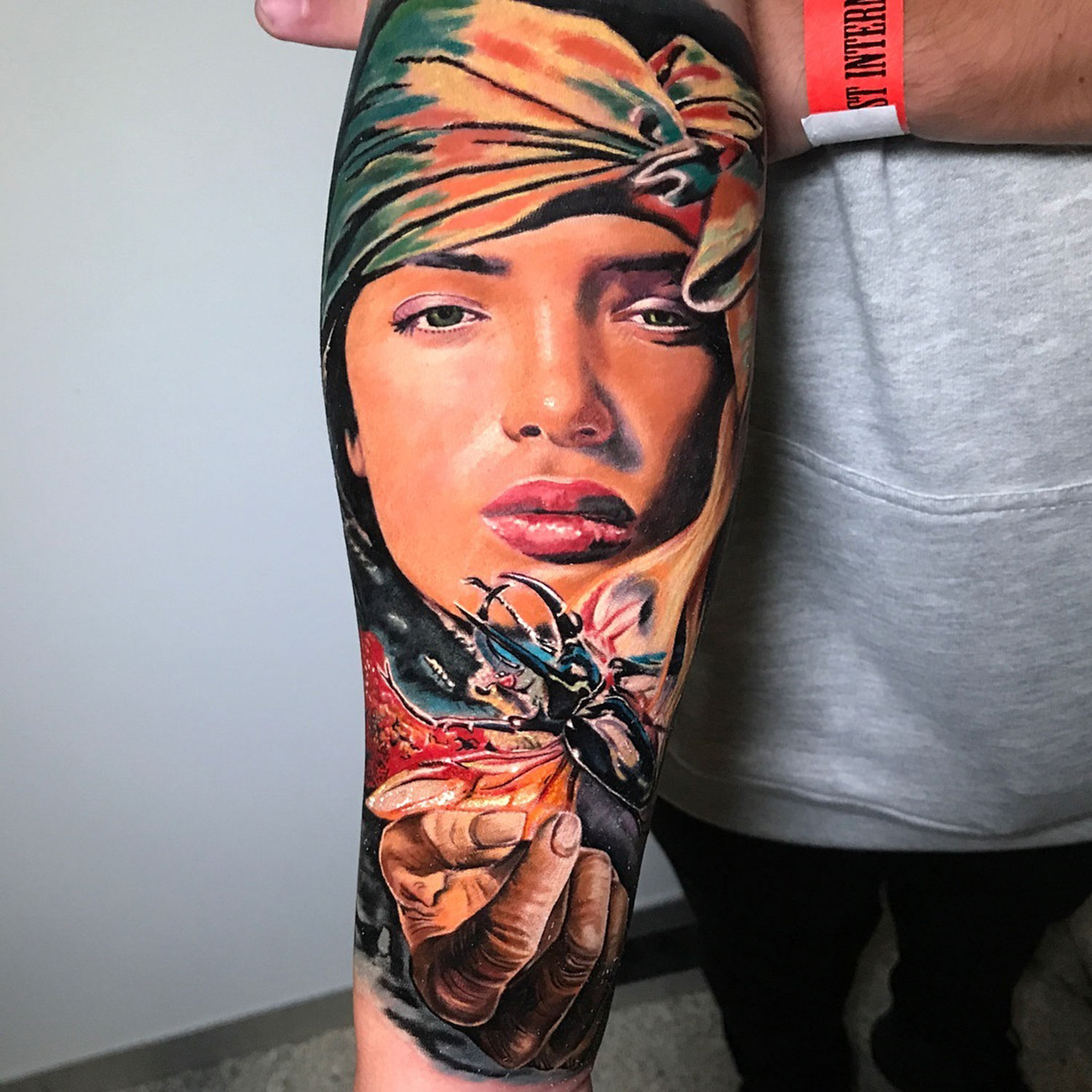 colorful portrait, realistic tattoo on arm, tattoo convention