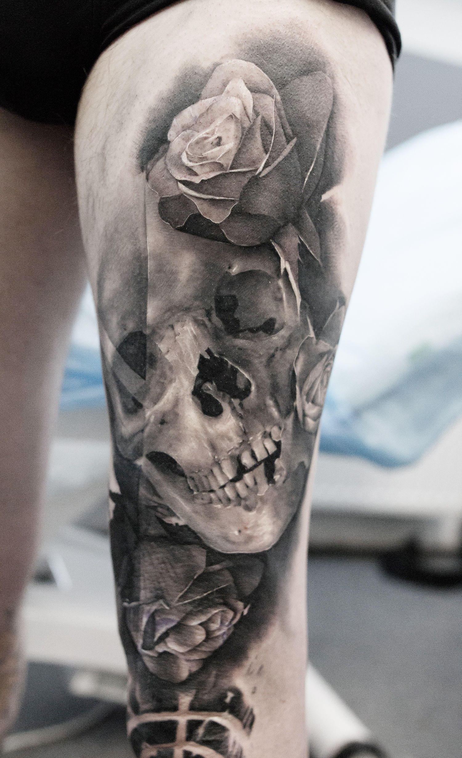 skull and rose tattoo on leg, black and grey tattoos