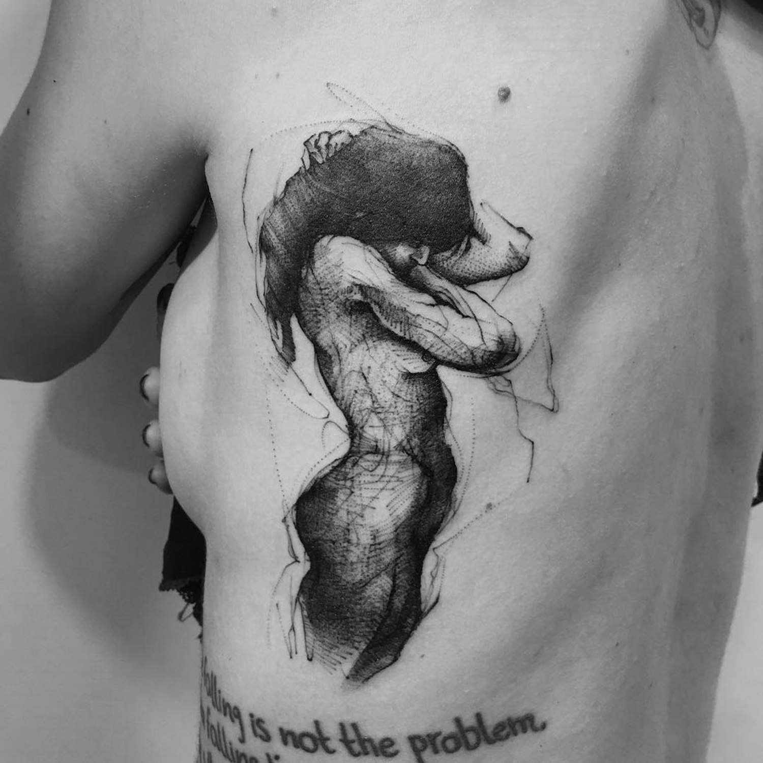 woman tattooed on ribs