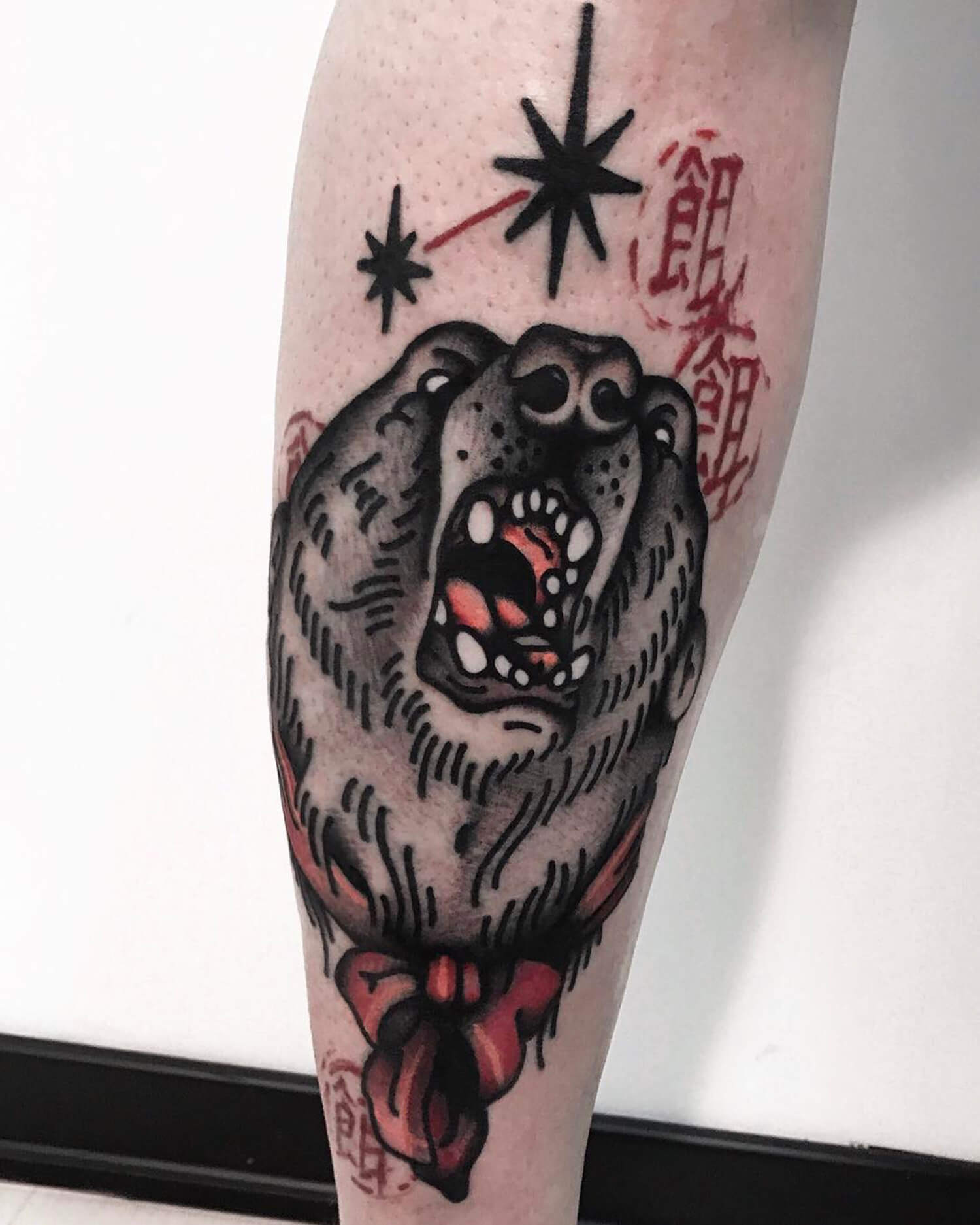 Bear tattoo on leg