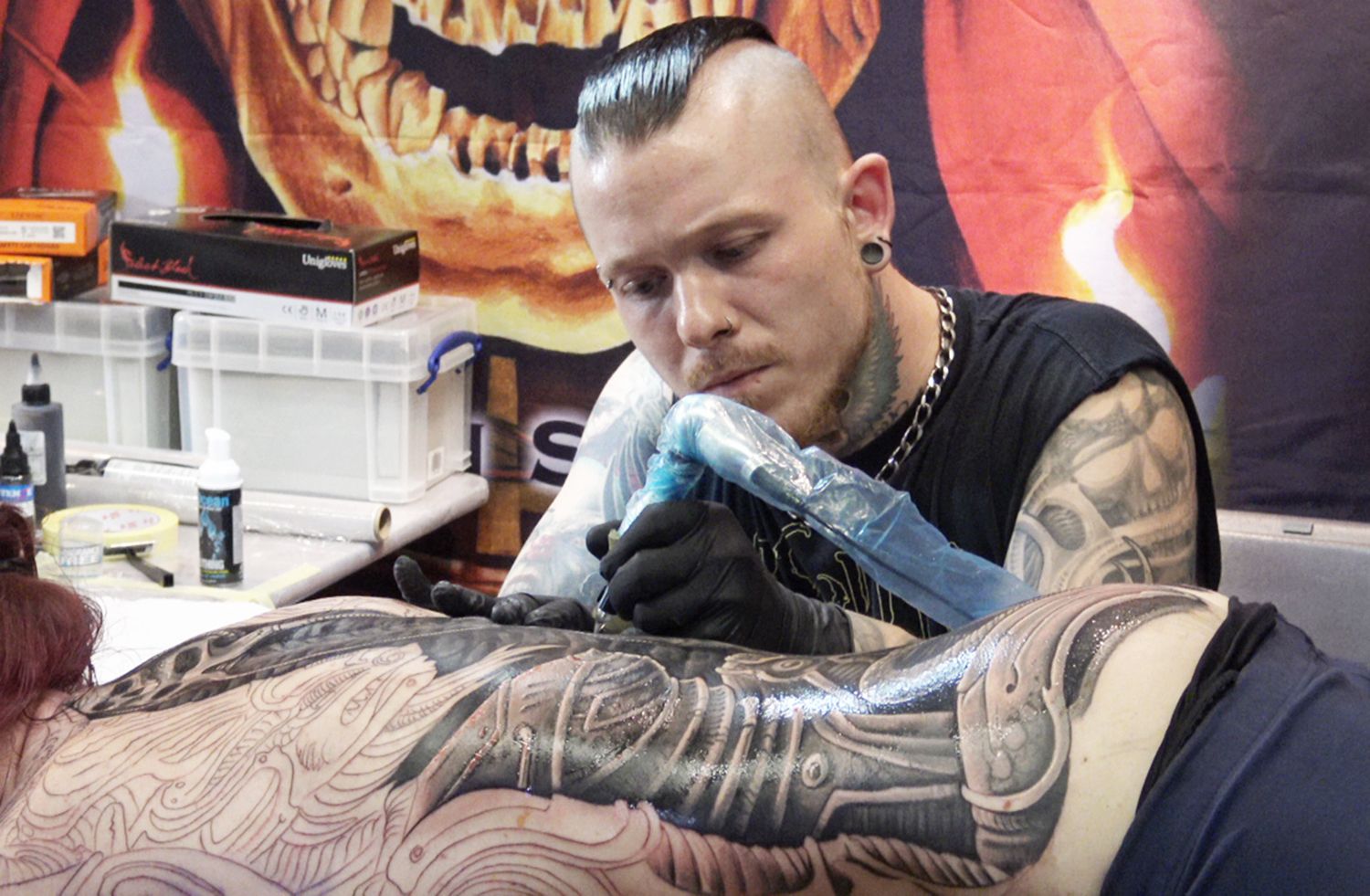 Julian Siebert tattooing a double baphomet biomechanical back piece, tattoo, berlin tattoo convention