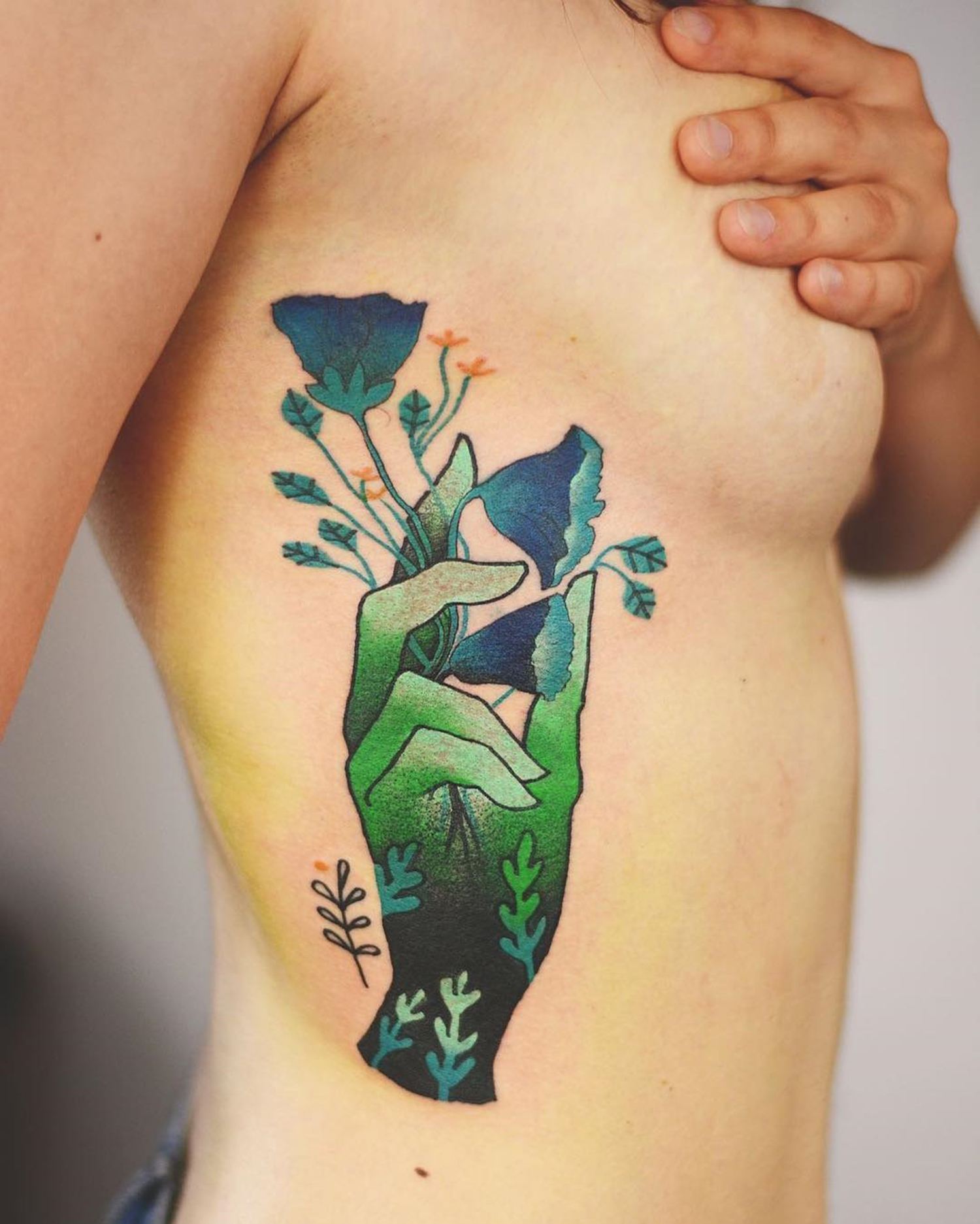 hand and nature, green tattoo