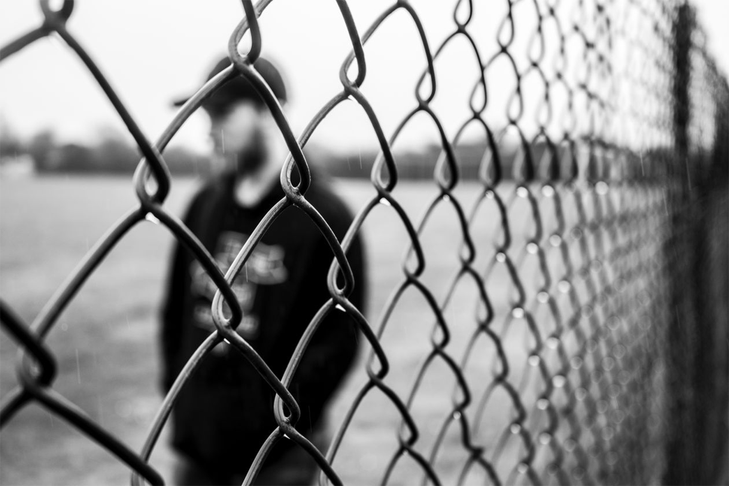 guy behind fence, free photo